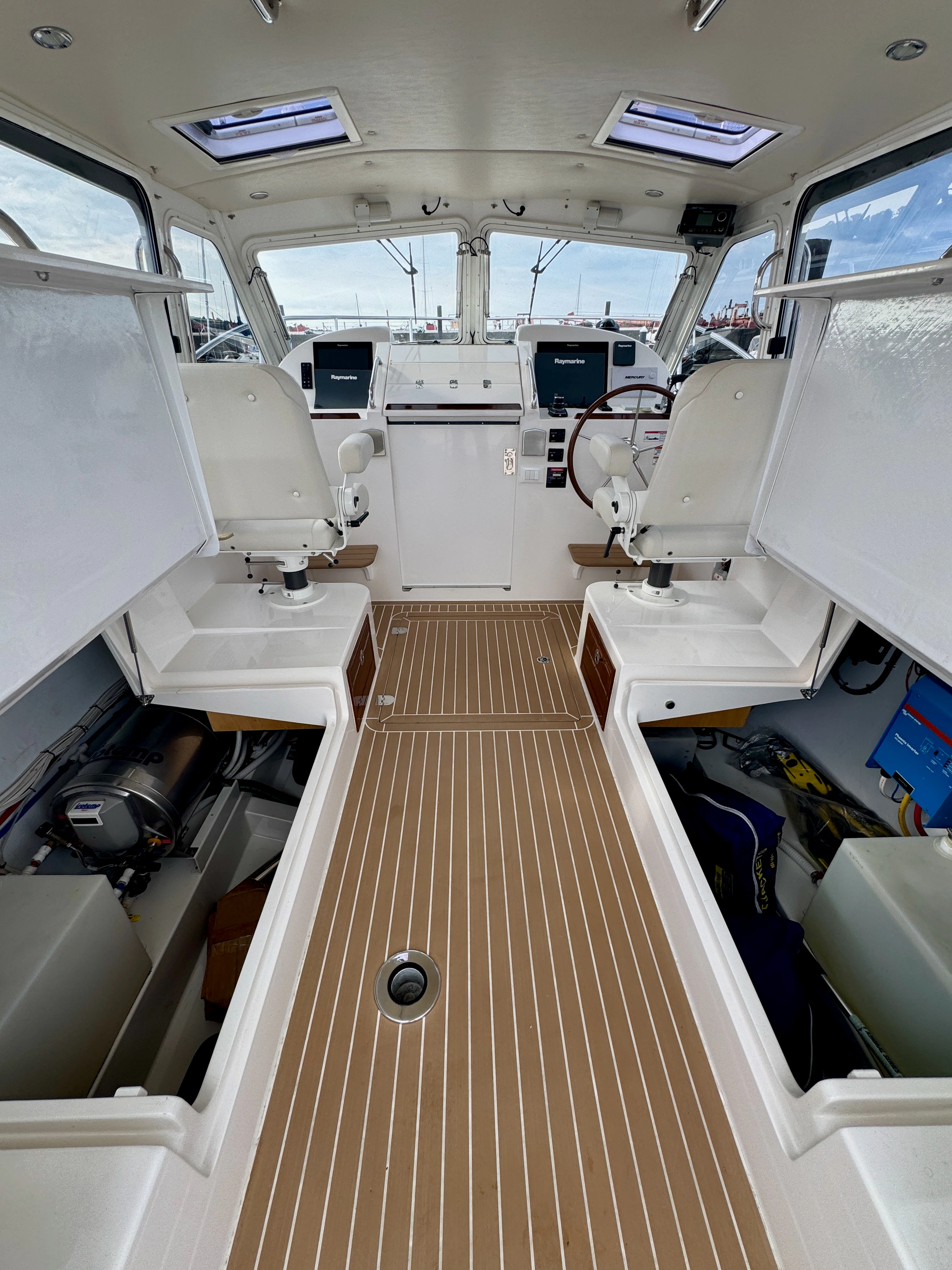 a room with a wood floor and white cabinets aboard MARE Yacht for Sale