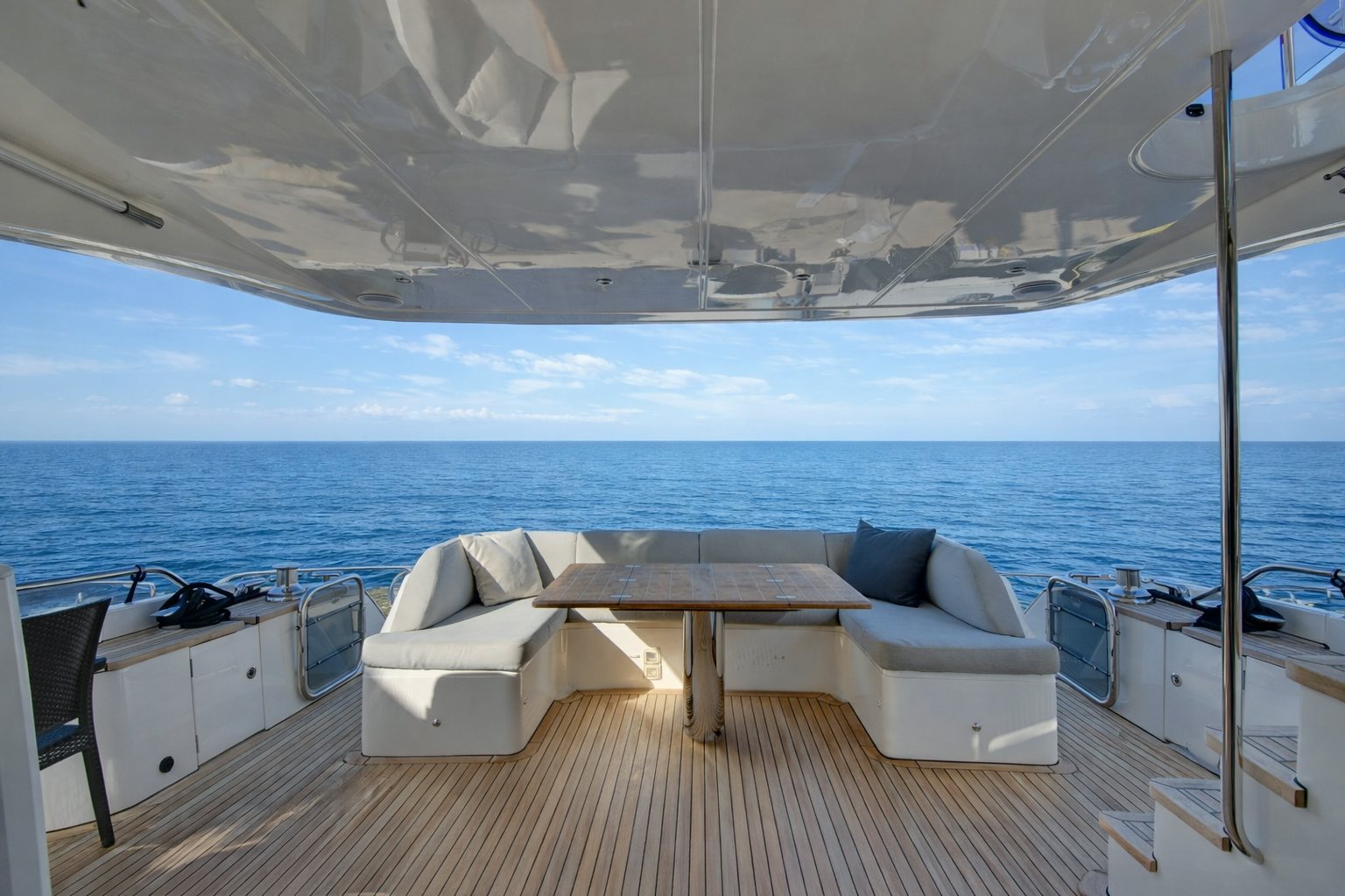 a room with a couch and a table and a view of the ocean aboard GRAND CRU Yacht for Sale