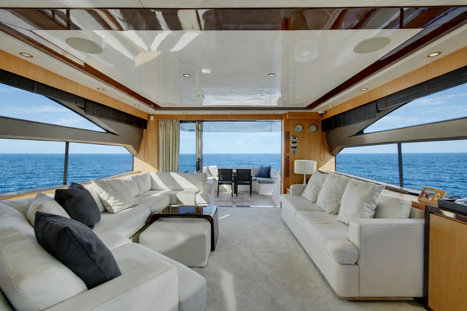 a room with a couch and a table and a large window aboard GRAND CRU Yacht for Sale
