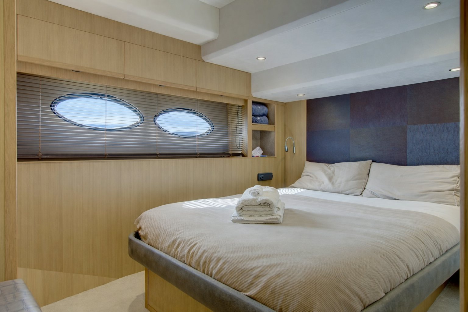 a bedroom with a bed and a window aboard GRAND CRU Yacht for Sale