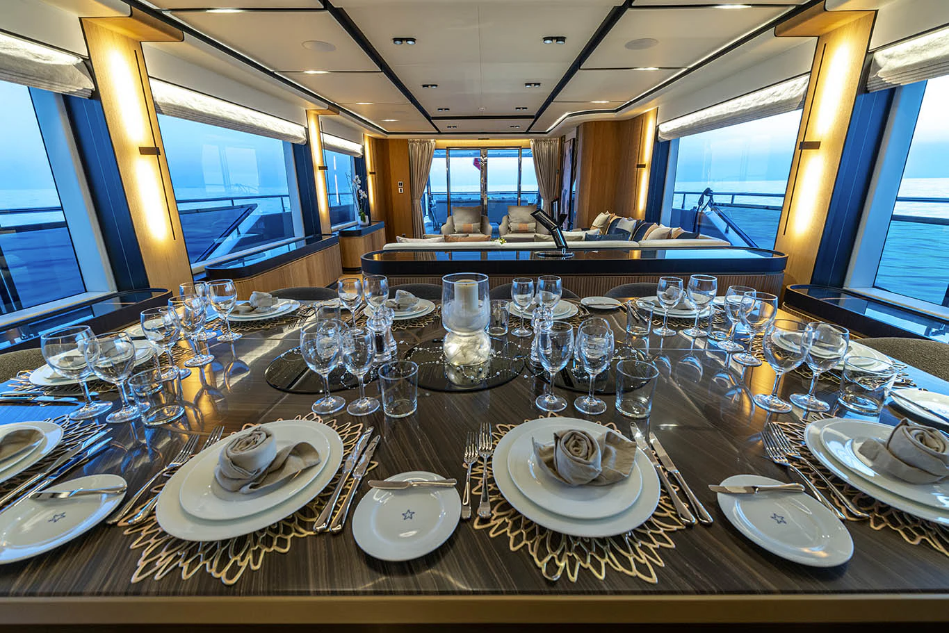 a large table with plates and glasses aboard ALKHADRA Yacht for Charter