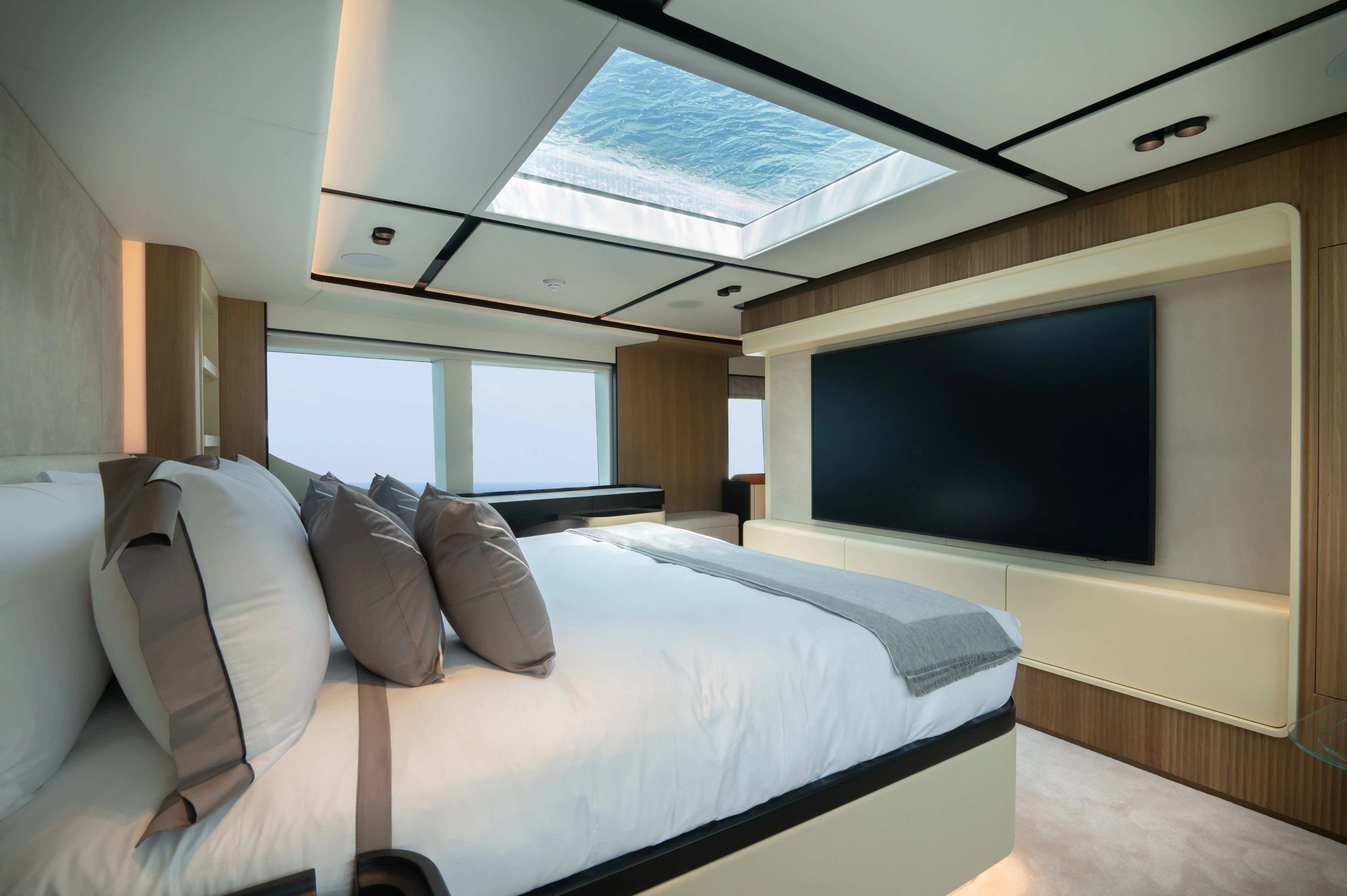 a bed with a television on the wall aboard ALKHADRA Yacht for Charter