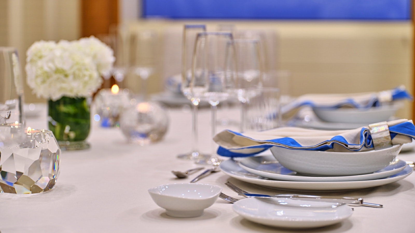 a table with plates and glasses aboard GELLY Yacht for Charter