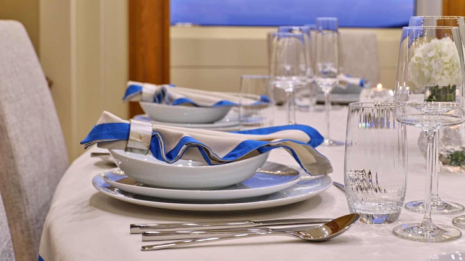 a plate of food and glasses on a table aboard GELLY Yacht for Charter