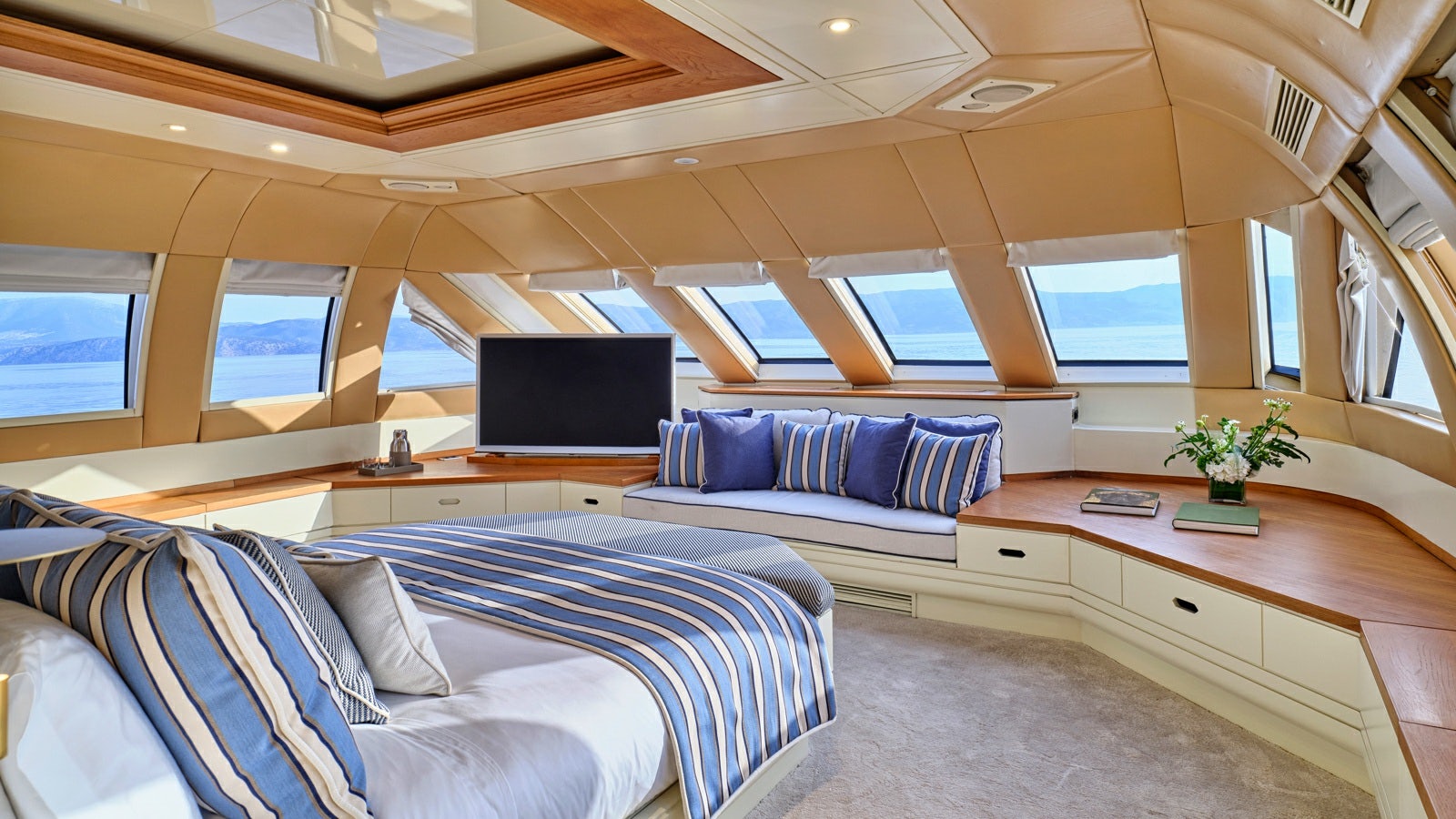 a room with a bed and a desk aboard GELLY Yacht for Charter