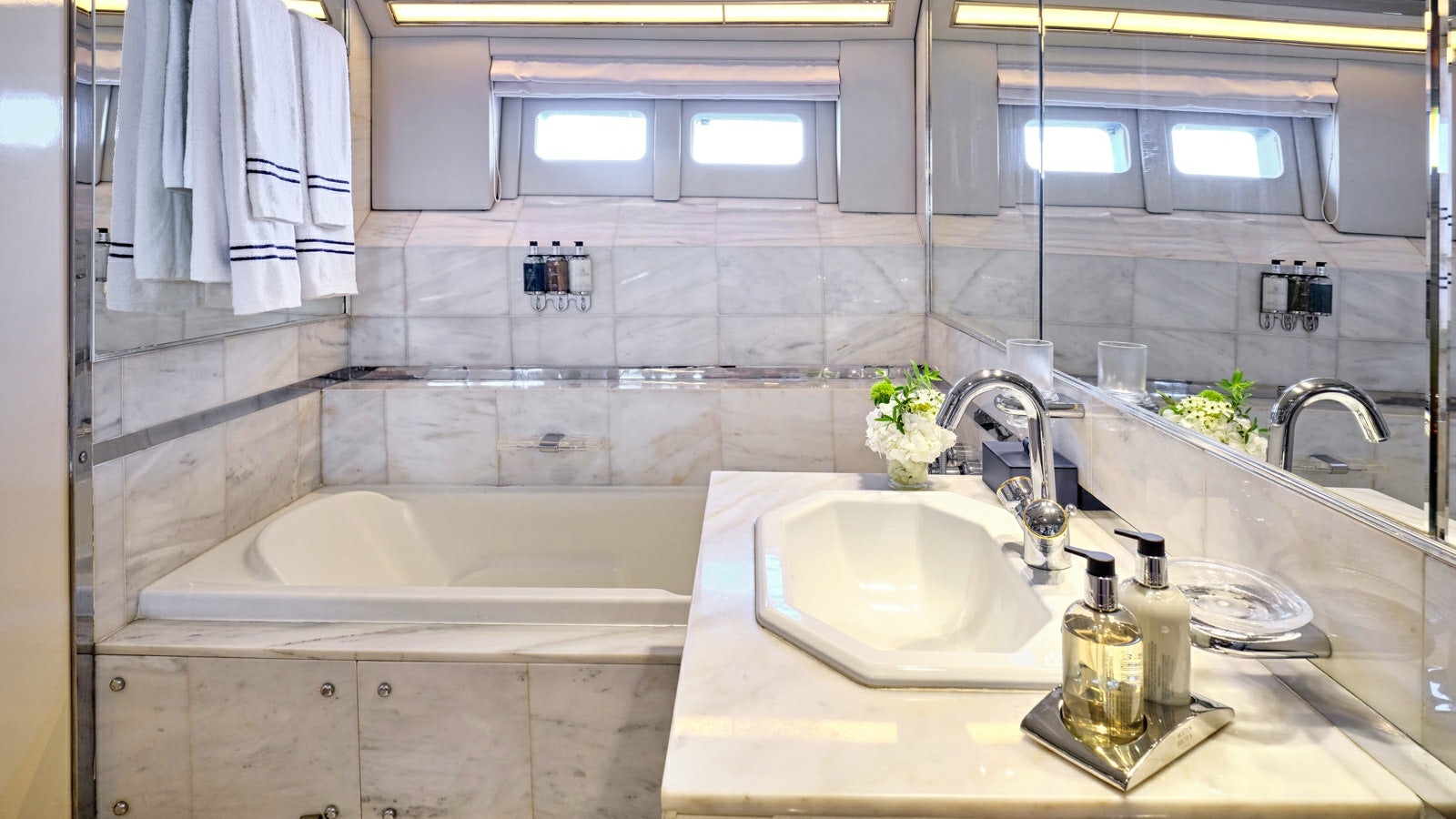 a bathroom with a bathtub sink and a sink aboard GELLY Yacht for Charter