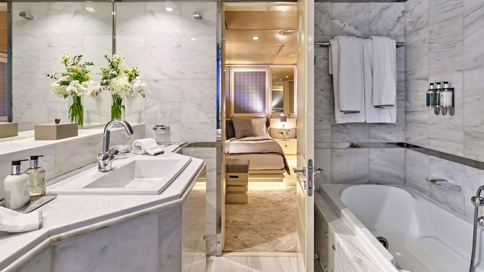 a bathroom with a bathtub sink and a sink aboard GELLY Yacht for Charter