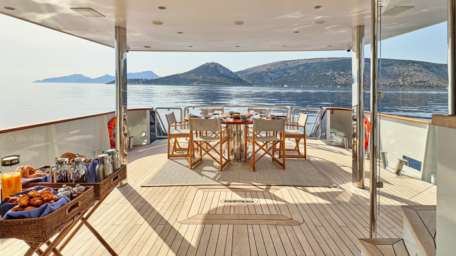 a patio with a table and chairs on it aboard GELLY Yacht for Charter