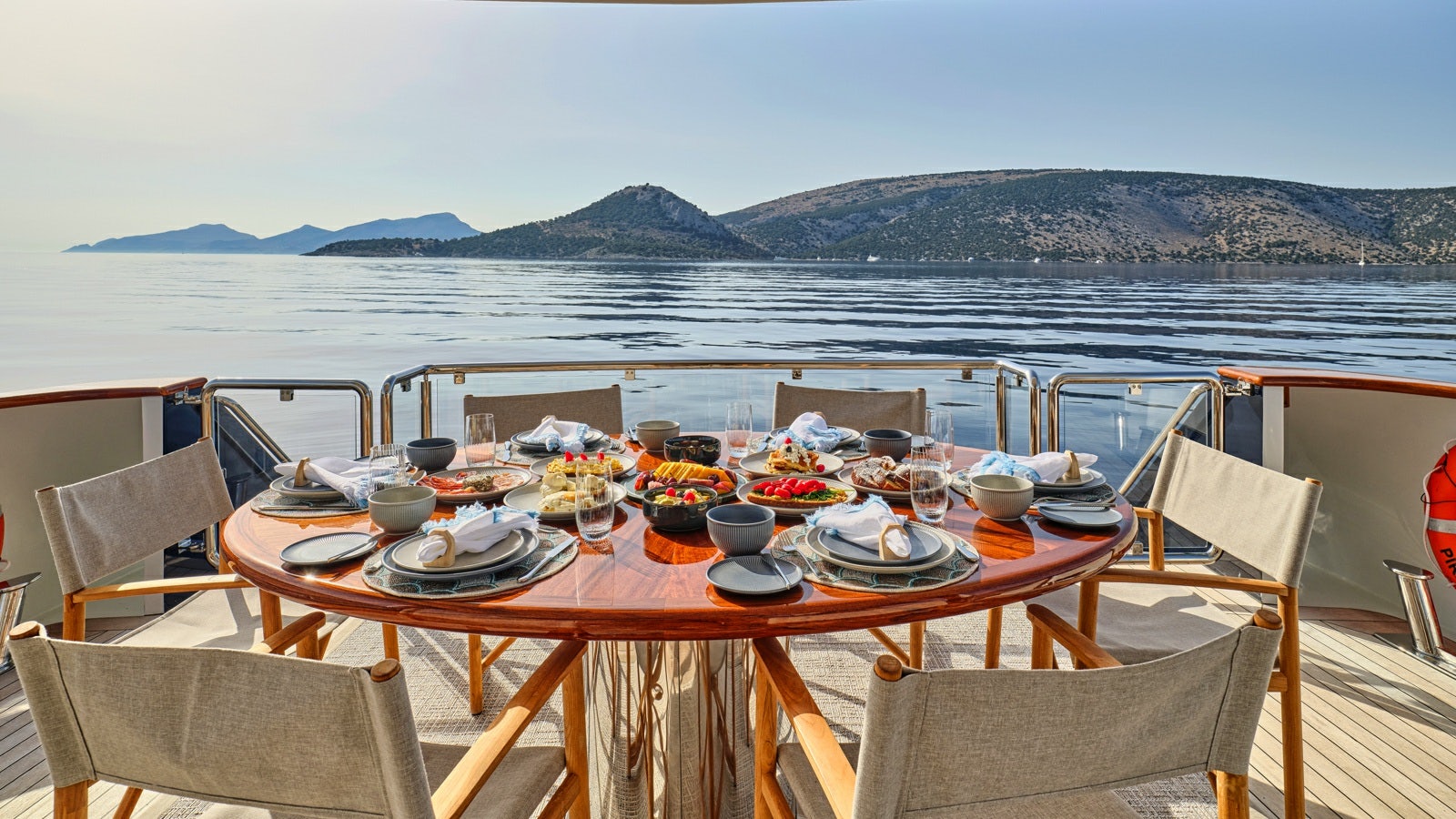 a table set with food and drinks on a boat aboard GELLY Yacht for Charter