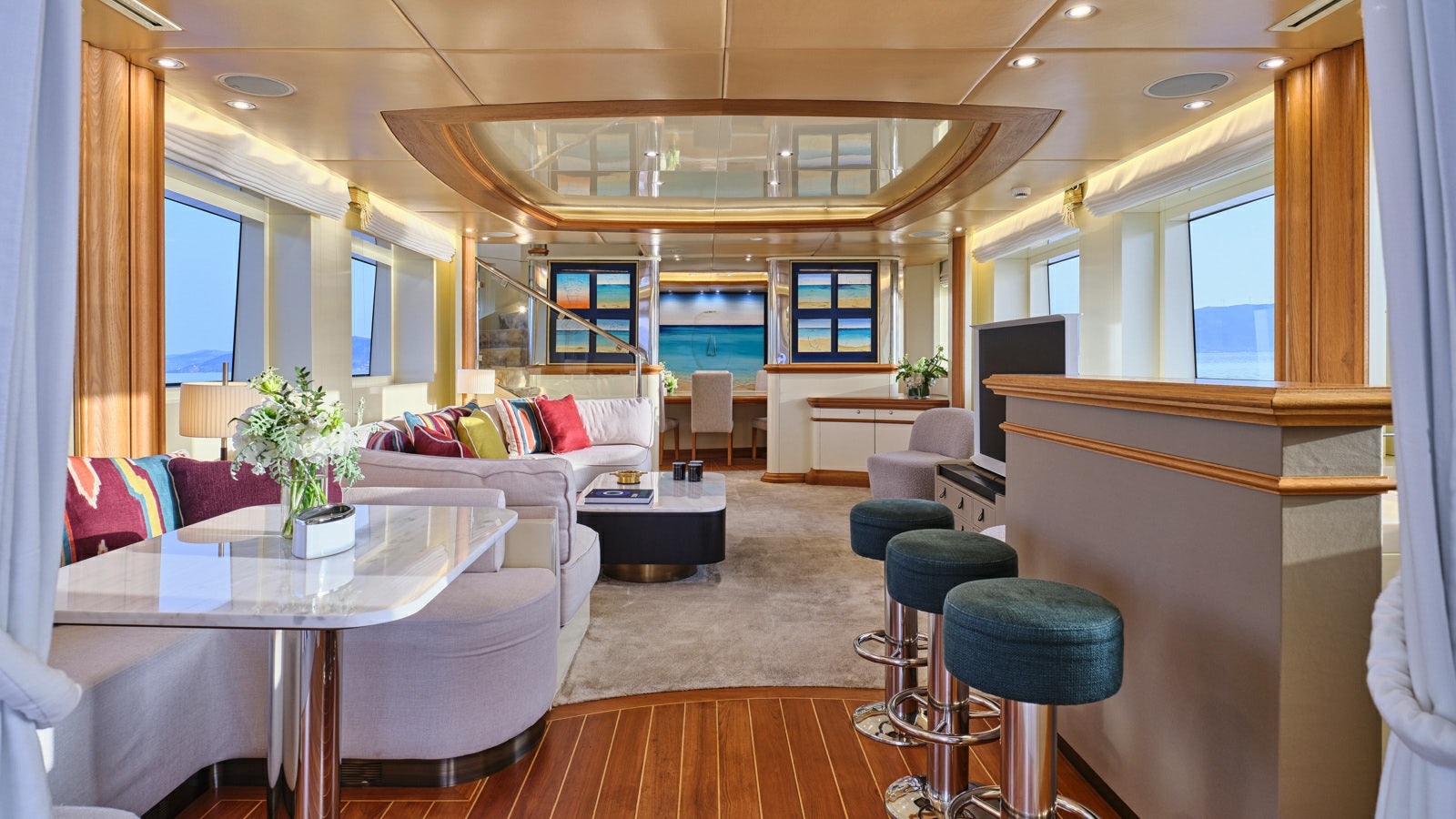 a living room with a table and couches aboard GELLY Yacht for Charter