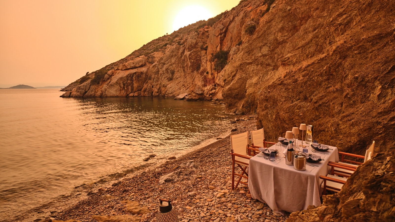 a table set on a beach aboard GELLY Yacht for Charter