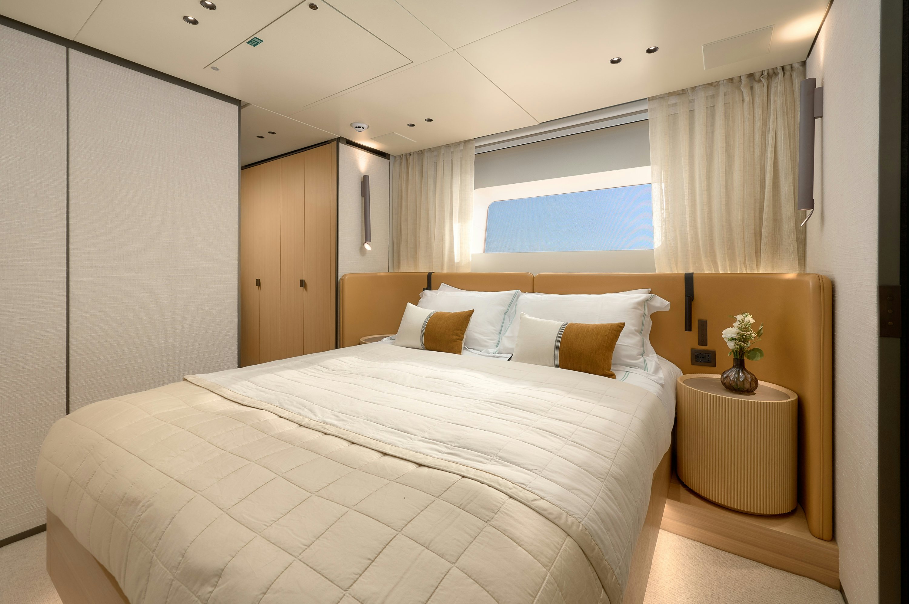 a bed with white sheets aboard AZZURRI Yacht for Charter
