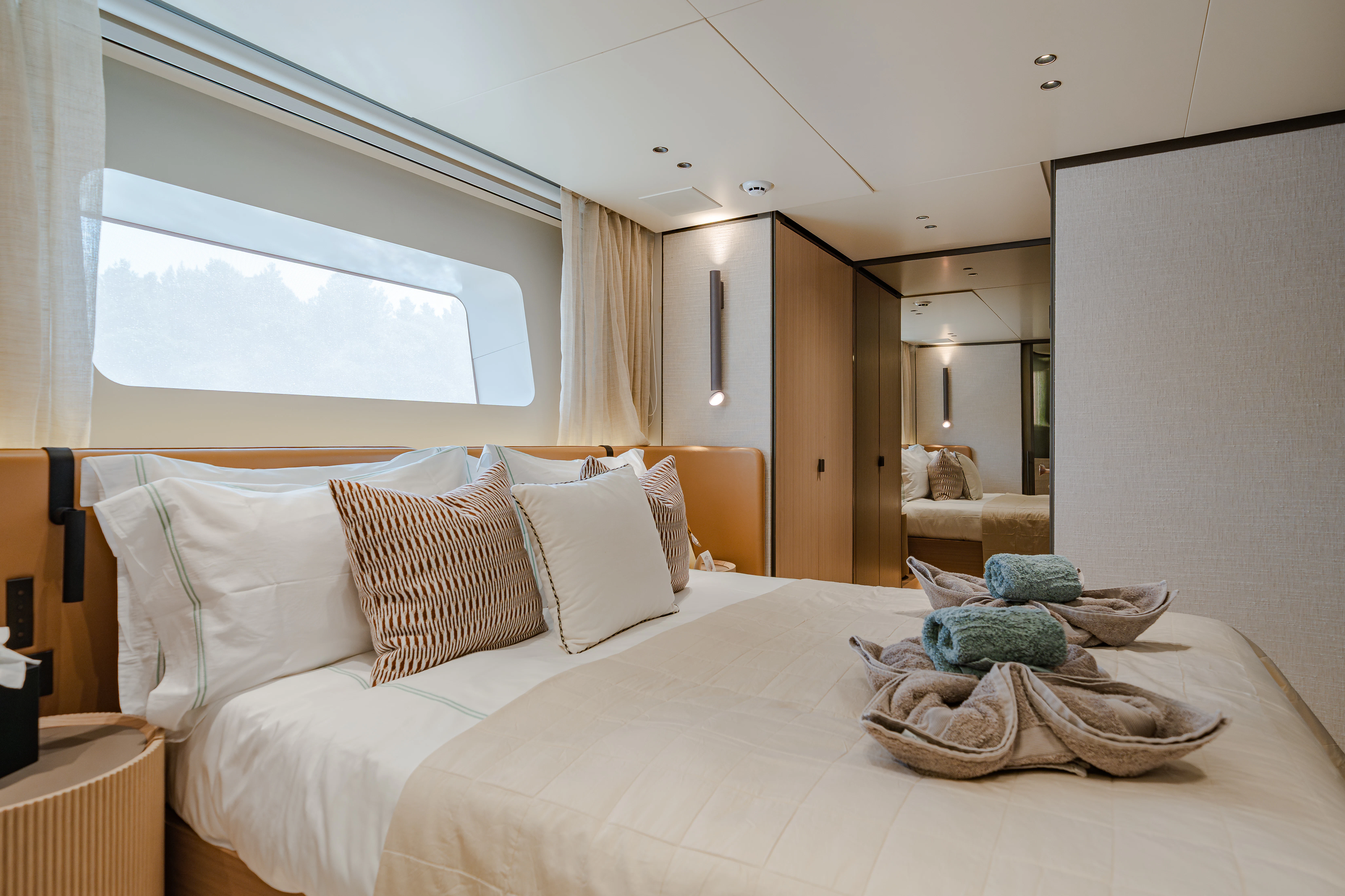 a bed with a white bed spread aboard AZZURRI Yacht for Charter