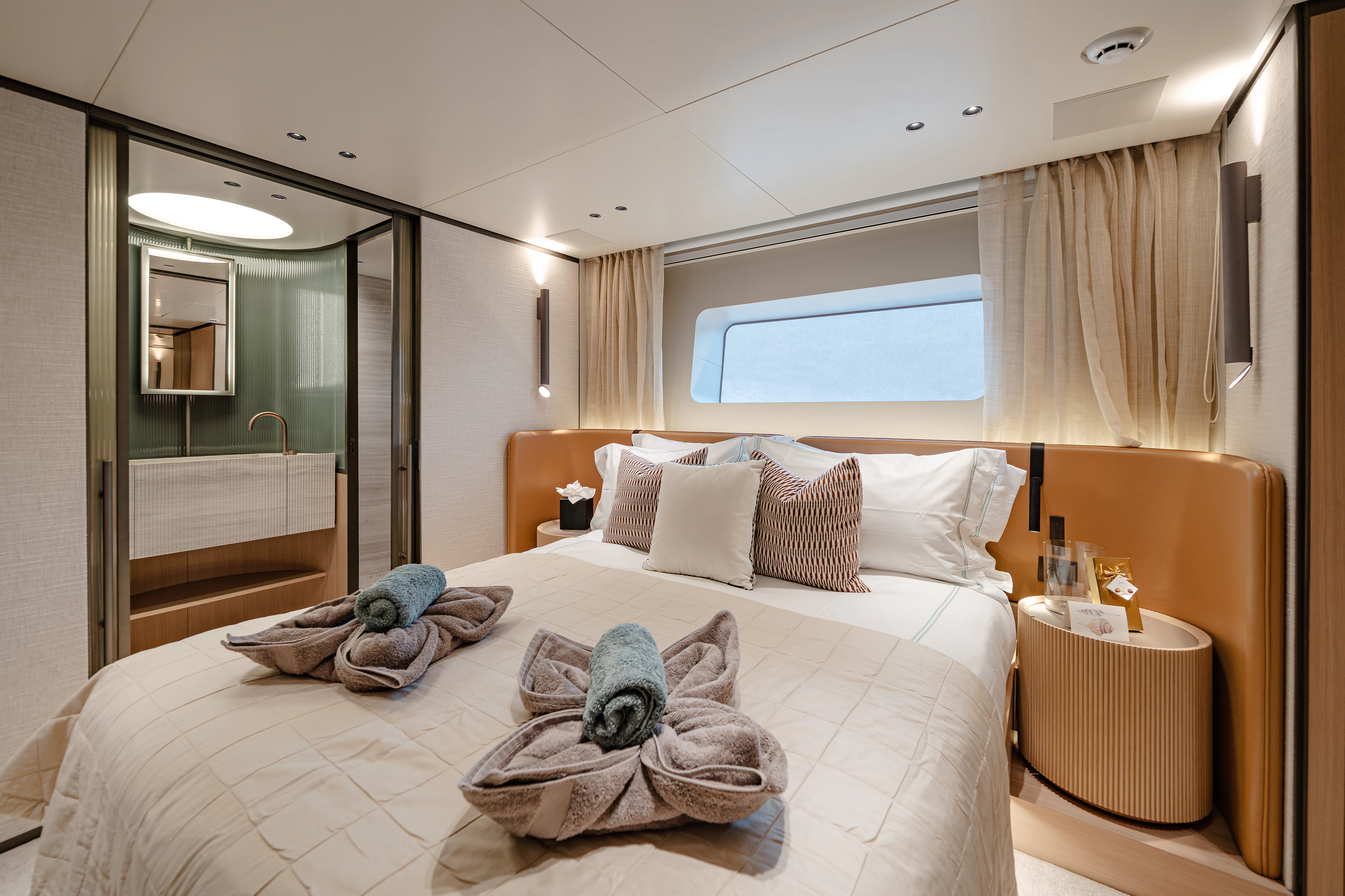 a bed with a large mirror aboard AZZURRI Yacht for Charter