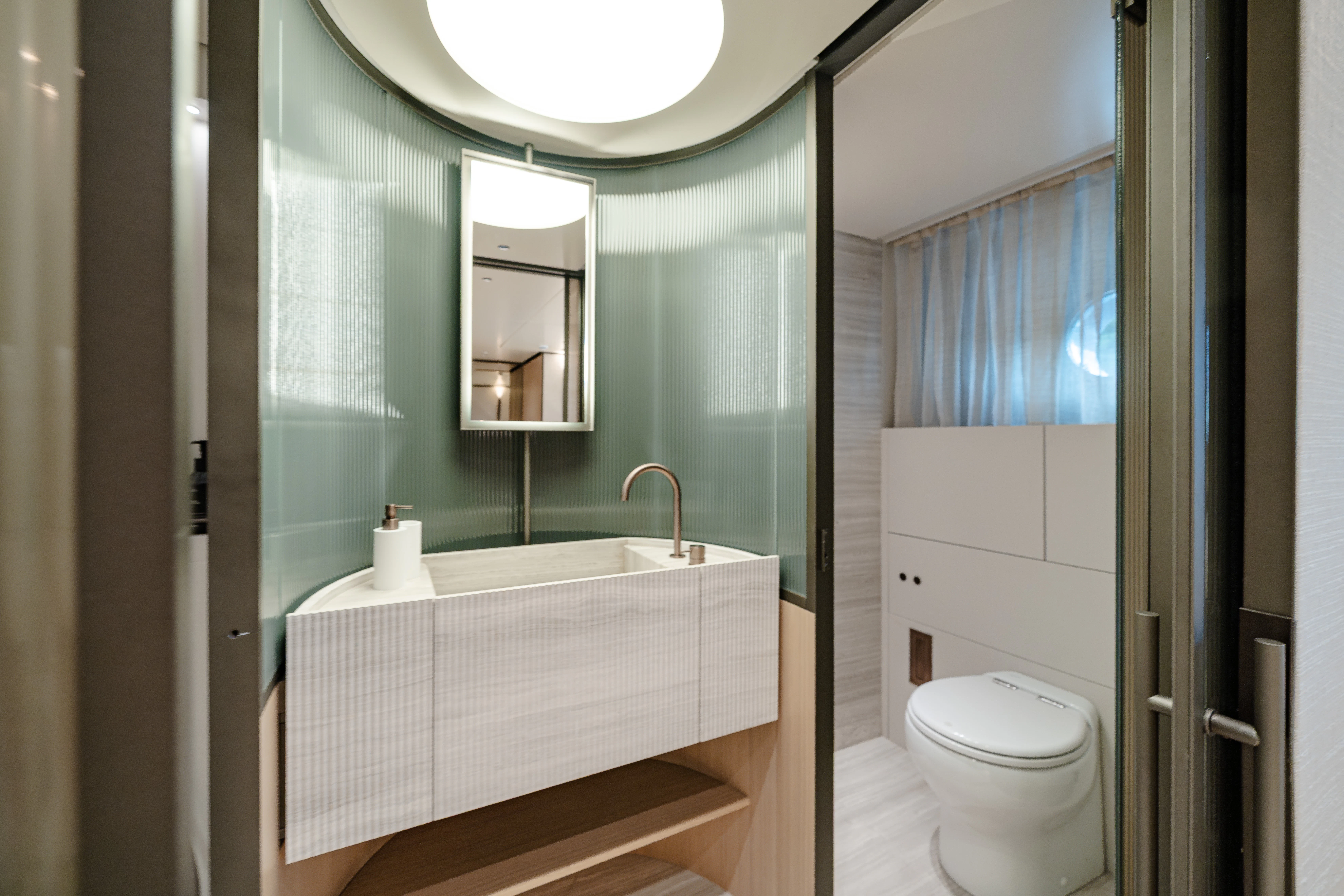 a bathroom with a large mirror aboard AZZURRI Yacht for Charter