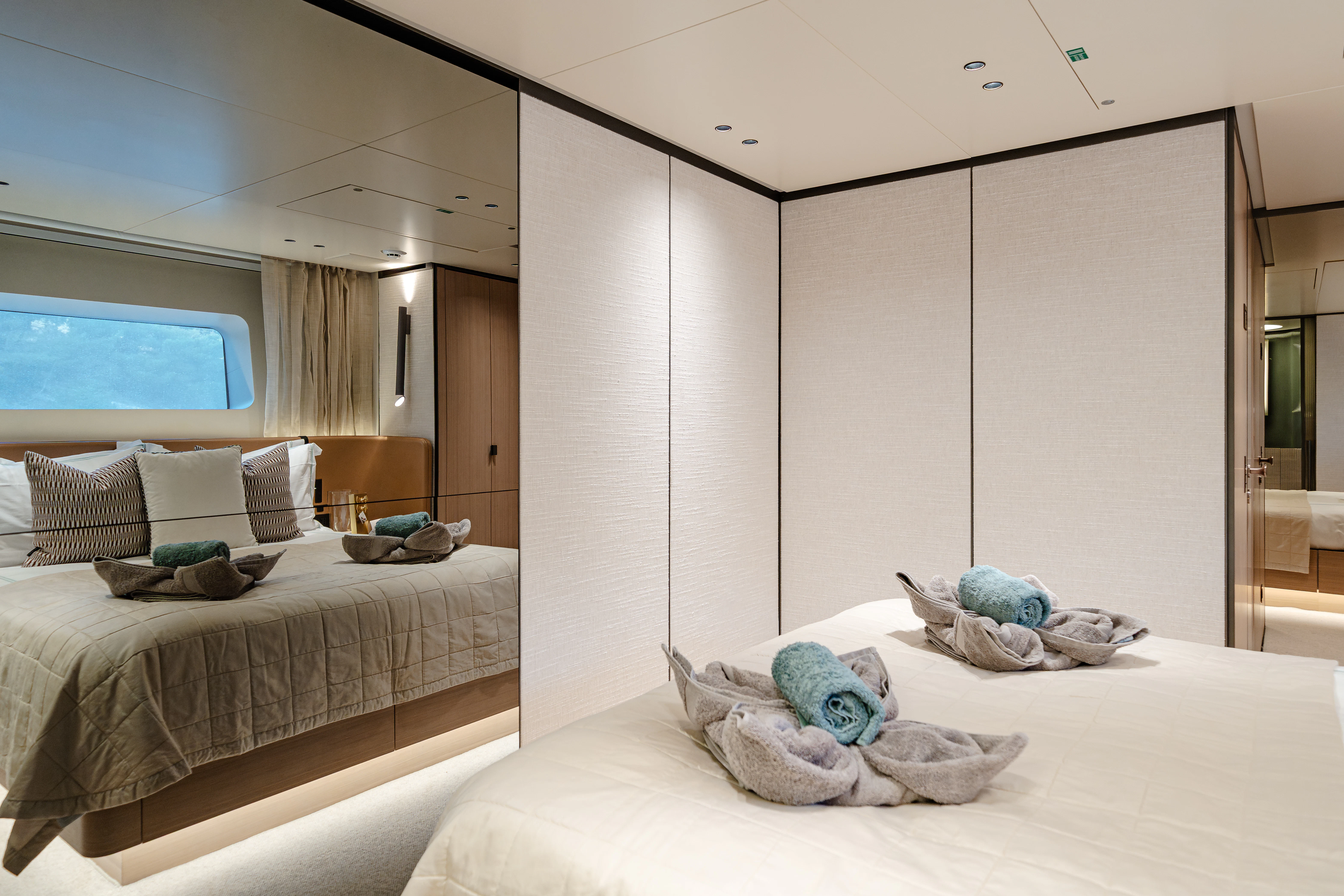 a bedroom with a bed and a mirror aboard AZZURRI Yacht for Charter