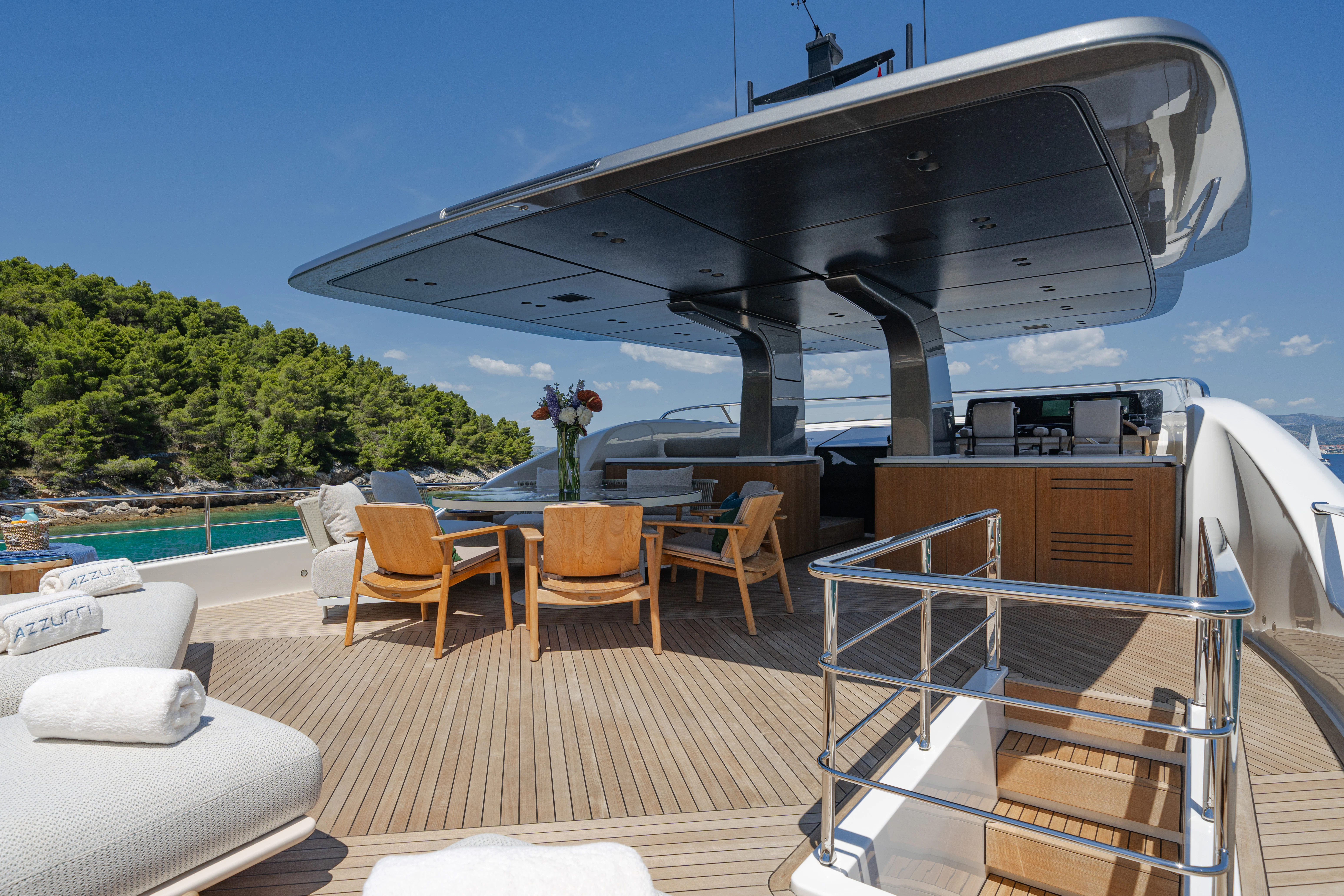 a deck with a pool and a deck with chairs and a deck aboard AZZURRI Yacht for Charter