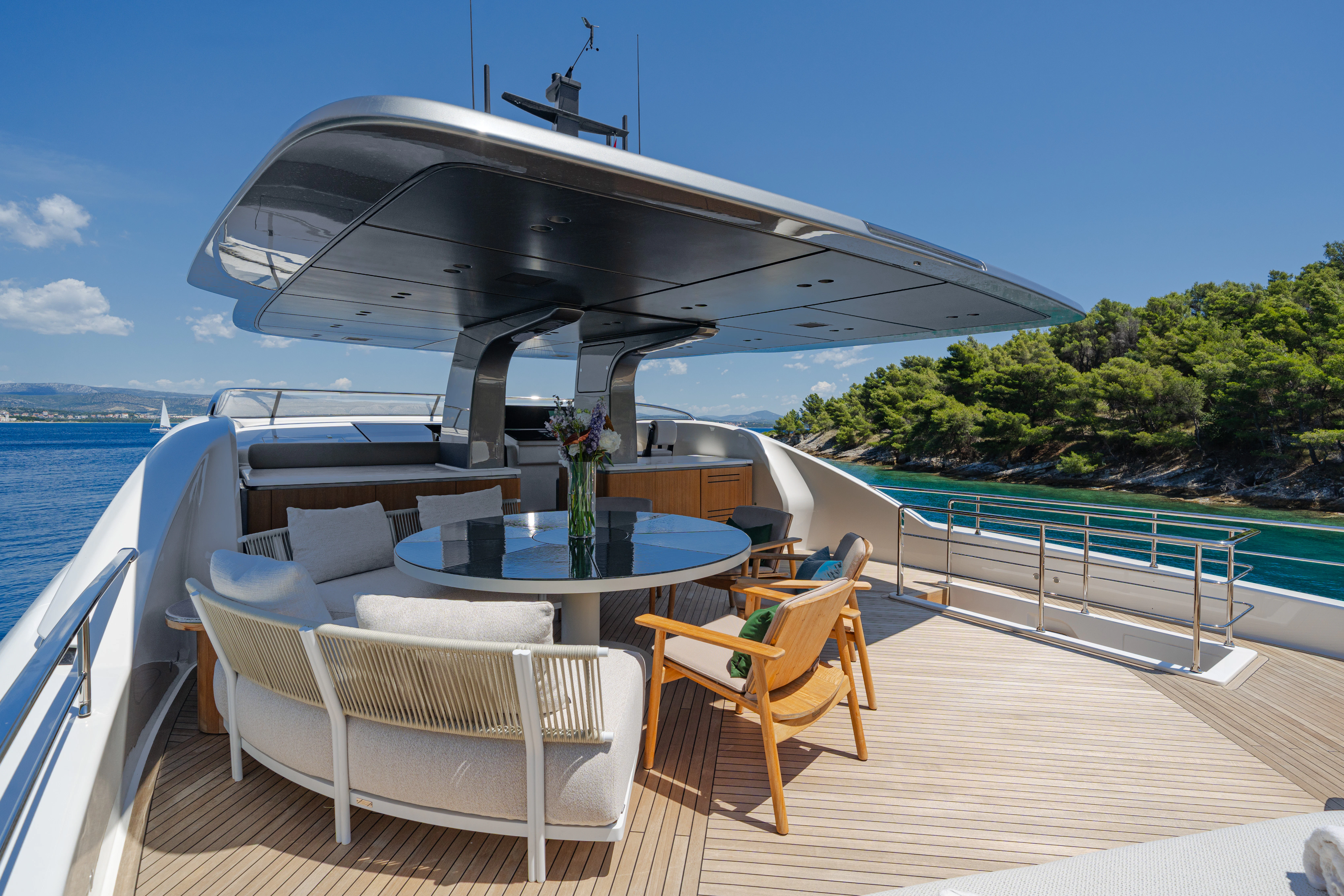 a deck with a table and chairs on it aboard AZZURRI Yacht for Charter