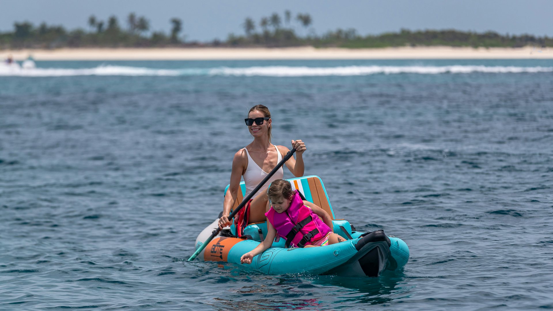 a man and a child on a raft in the water aboard HIGHLANDER Yacht for Charter