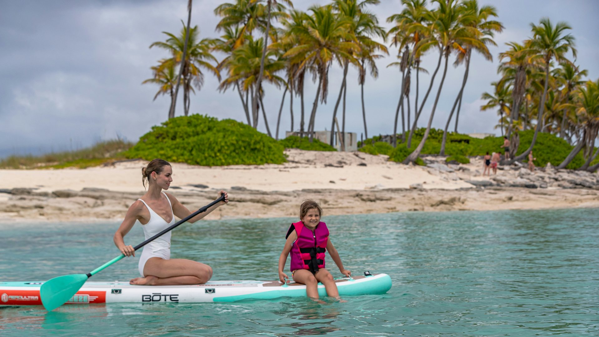 a couple of girls on surfboards in the water aboard HIGHLANDER Yacht for Charter