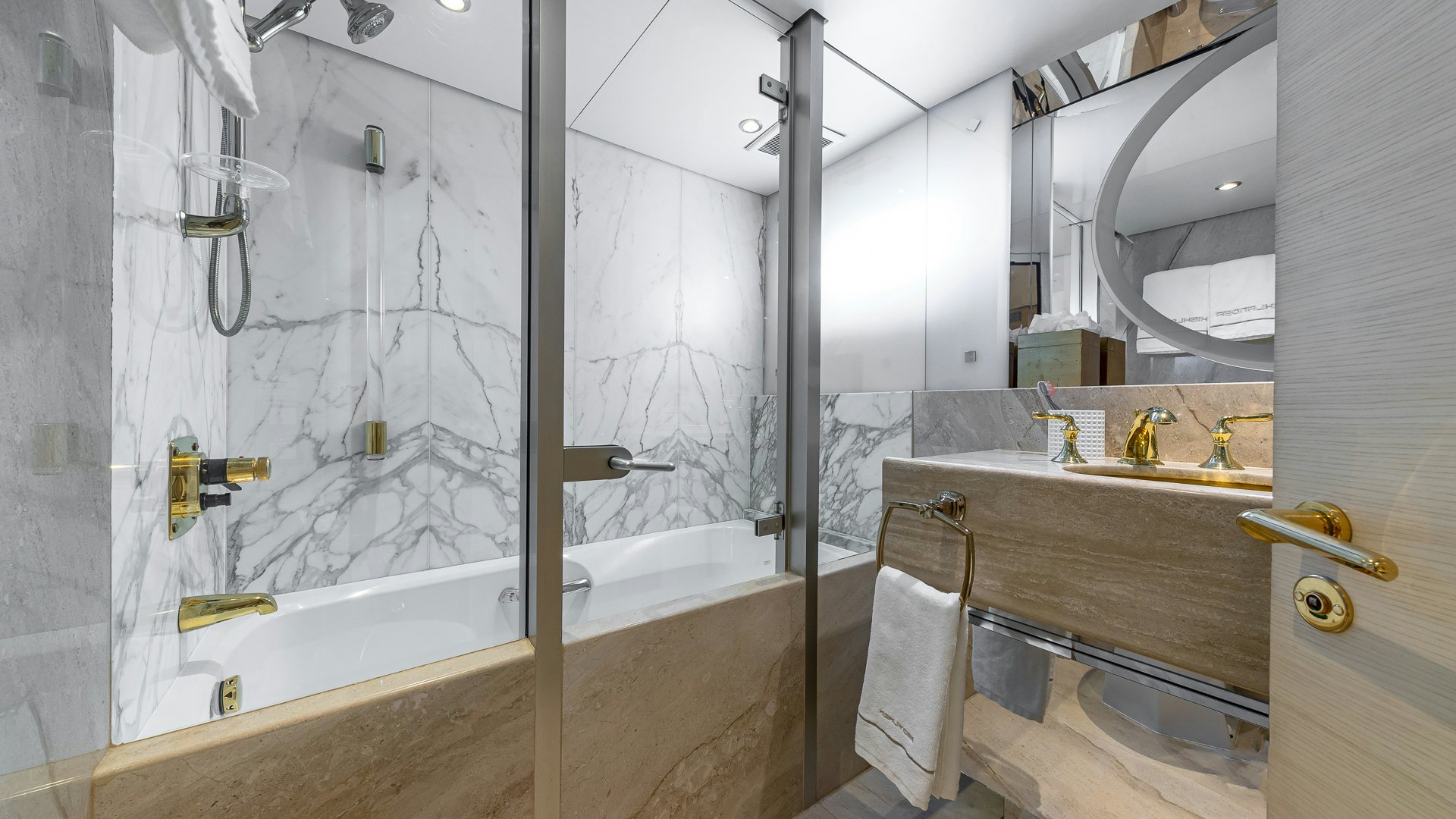 a bathroom with a bathtub and sink aboard HIGHLANDER Yacht for Charter