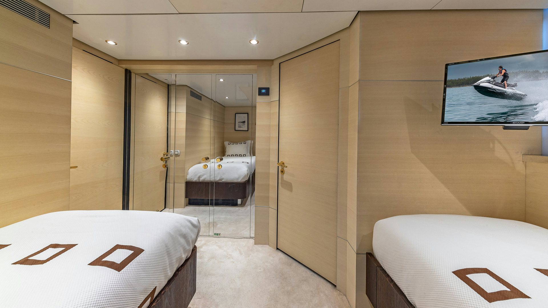 a room with a bed and a television aboard HIGHLANDER Yacht for Charter