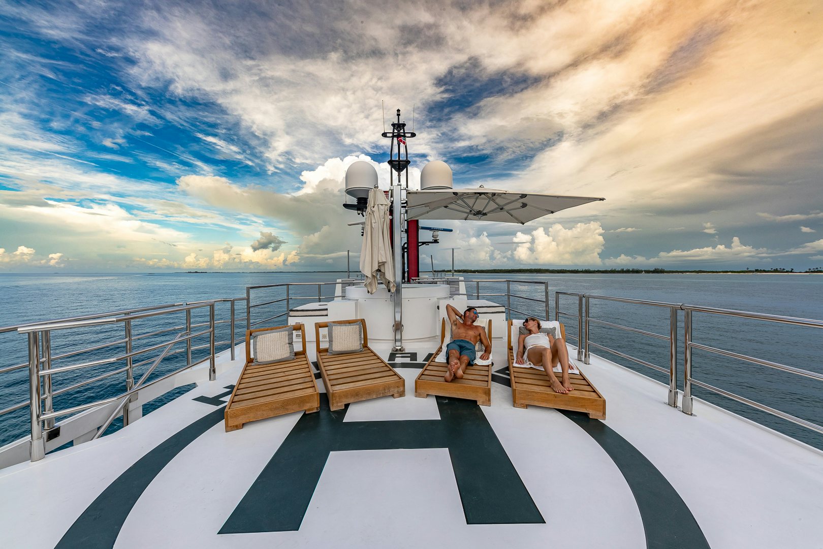 people sitting on a bench on a boat aboard HIGHLANDER Yacht for Charter