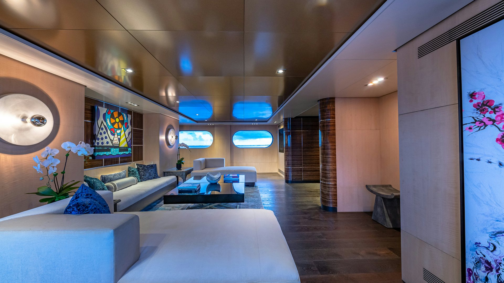 a room with a large window and a couch aboard HIGHLANDER Yacht for Charter