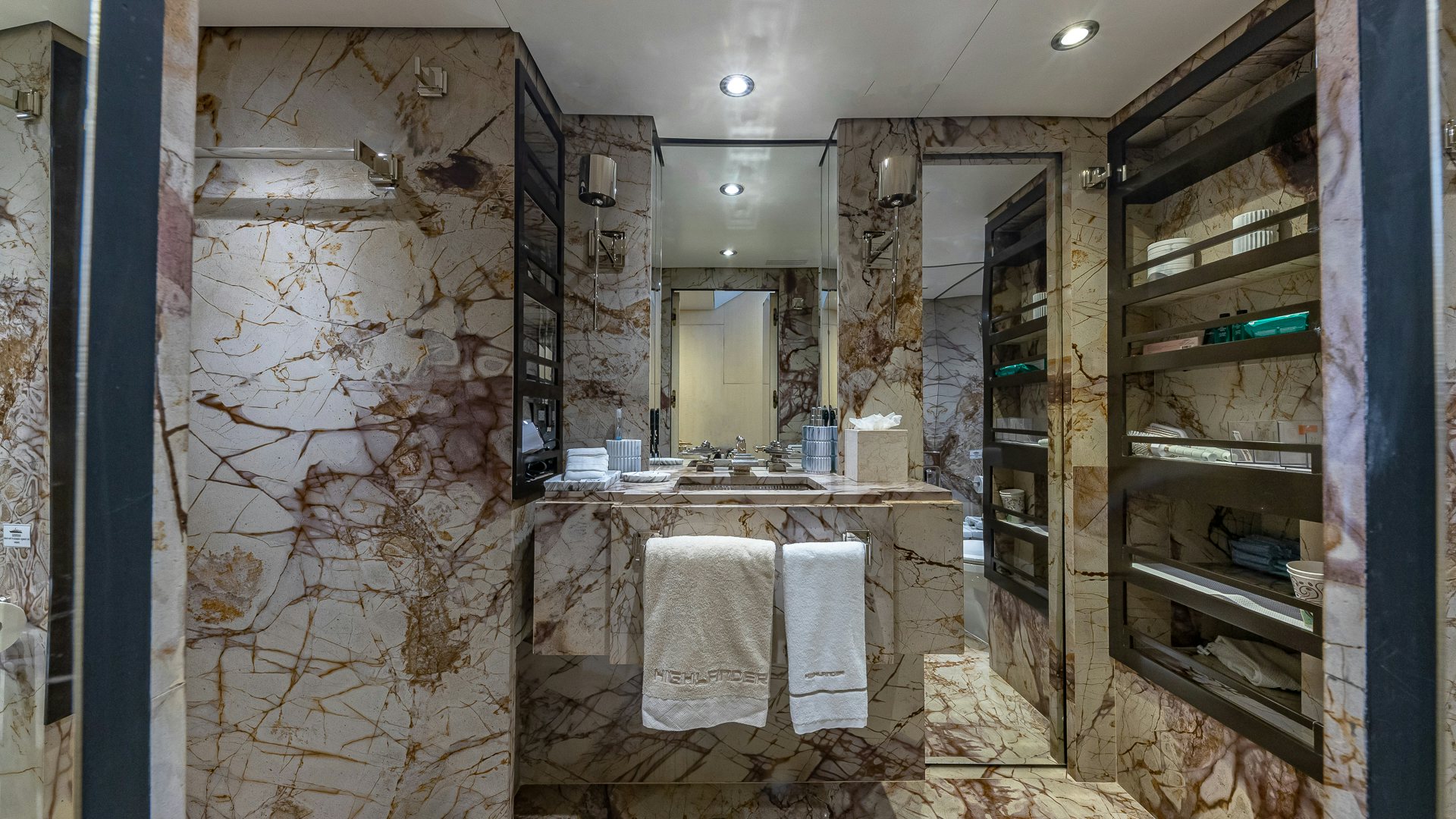 a bathroom with a large mirror aboard HIGHLANDER Yacht for Charter