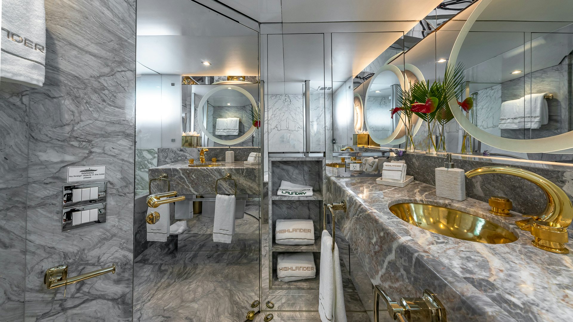 a bathroom with a sink and a mirror aboard HIGHLANDER Yacht for Charter
