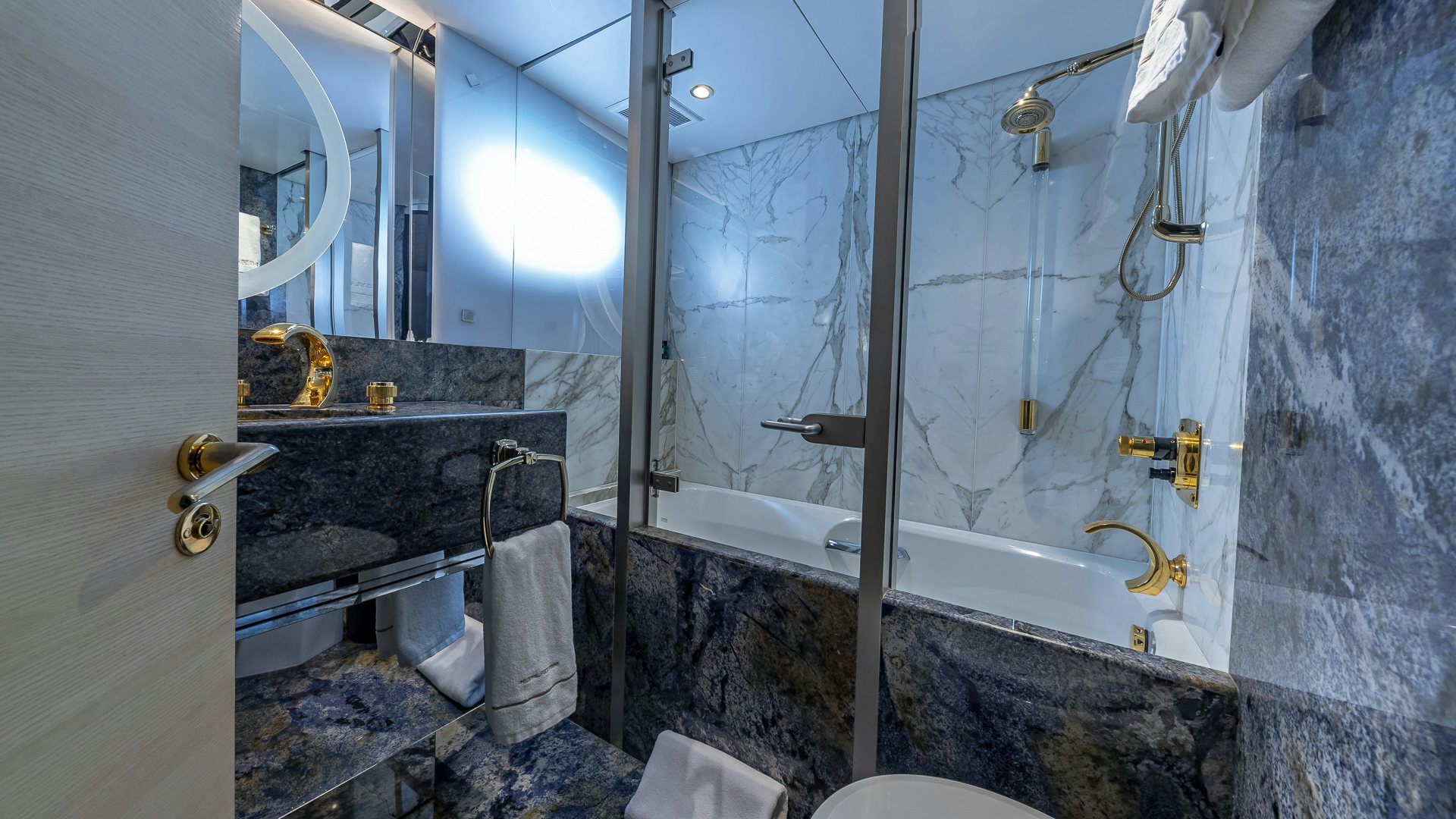 a bathroom with a bathtub and sink aboard HIGHLANDER Yacht for Charter
