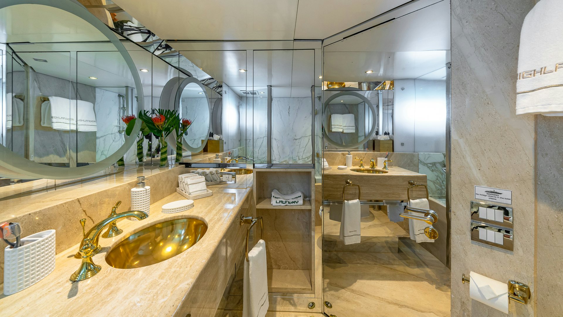 a bathroom with a sink and mirrors aboard HIGHLANDER Yacht for Charter