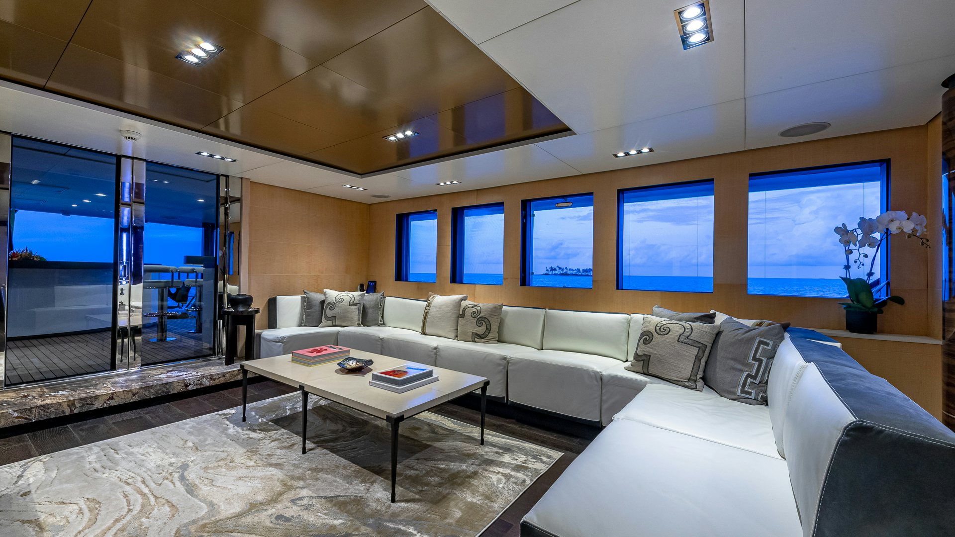 a living room with a large window aboard HIGHLANDER Yacht for Charter
