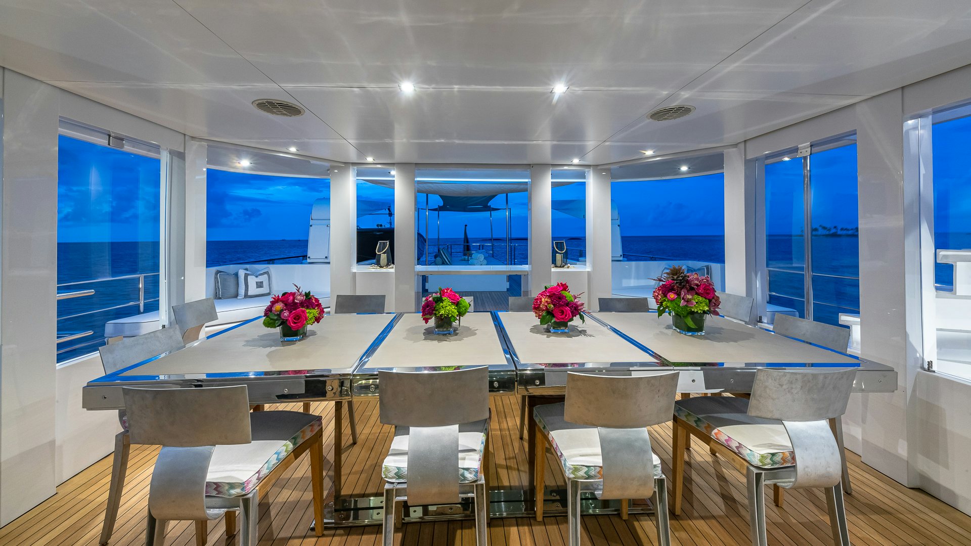 a large conference room with tables and chairs aboard HIGHLANDER Yacht for Charter