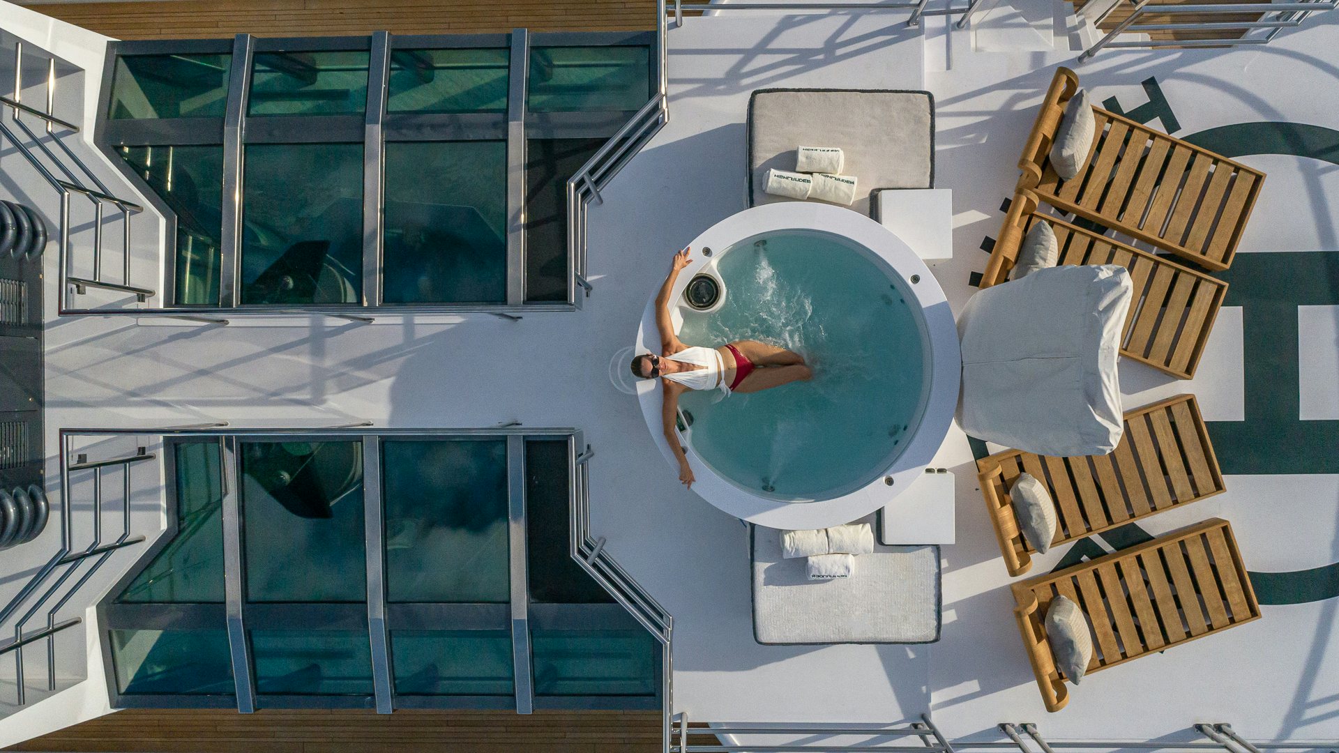 a person sitting in a chair aboard HIGHLANDER Yacht for Charter