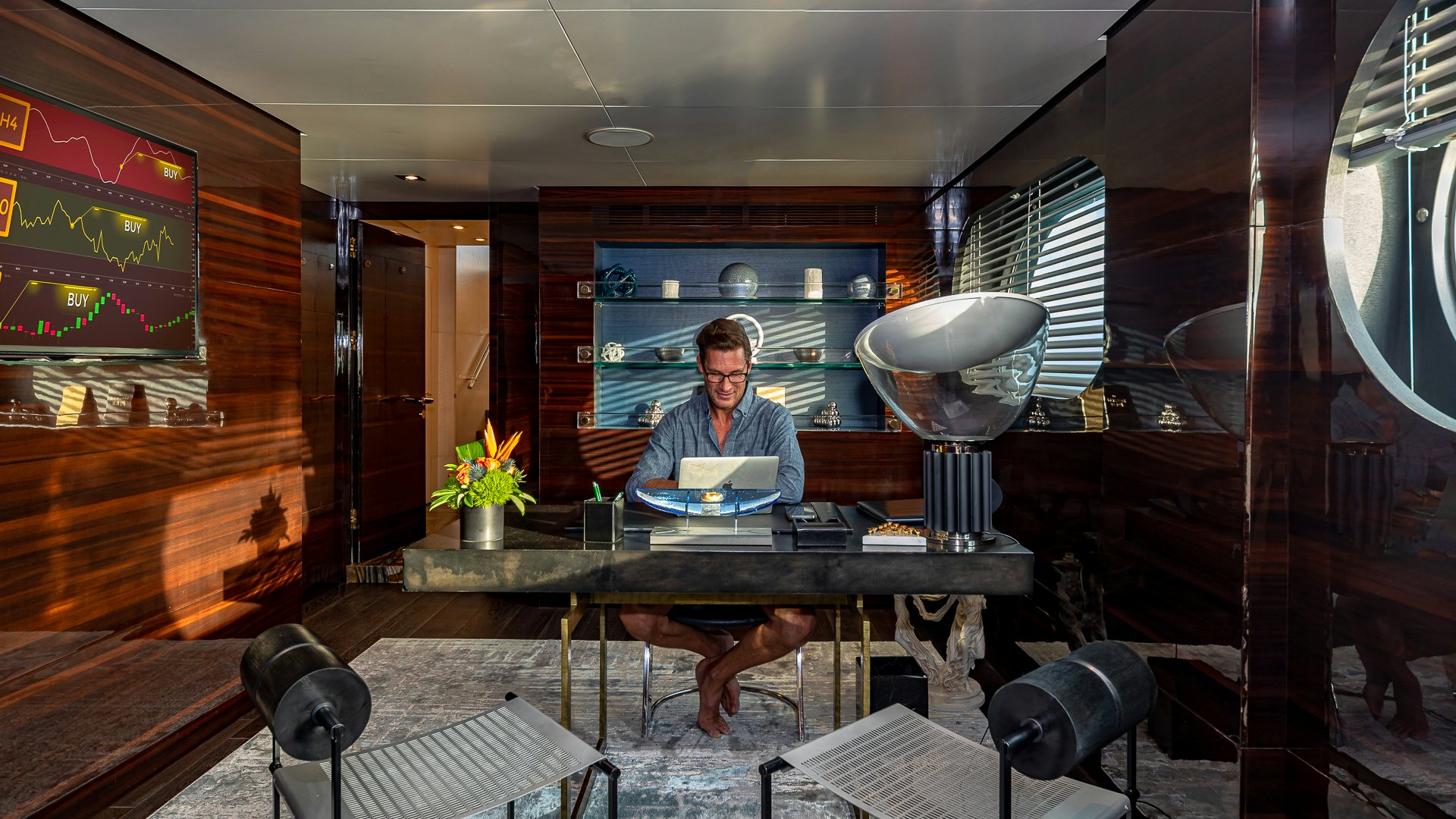 a person sitting at a table aboard HIGHLANDER Yacht for Charter