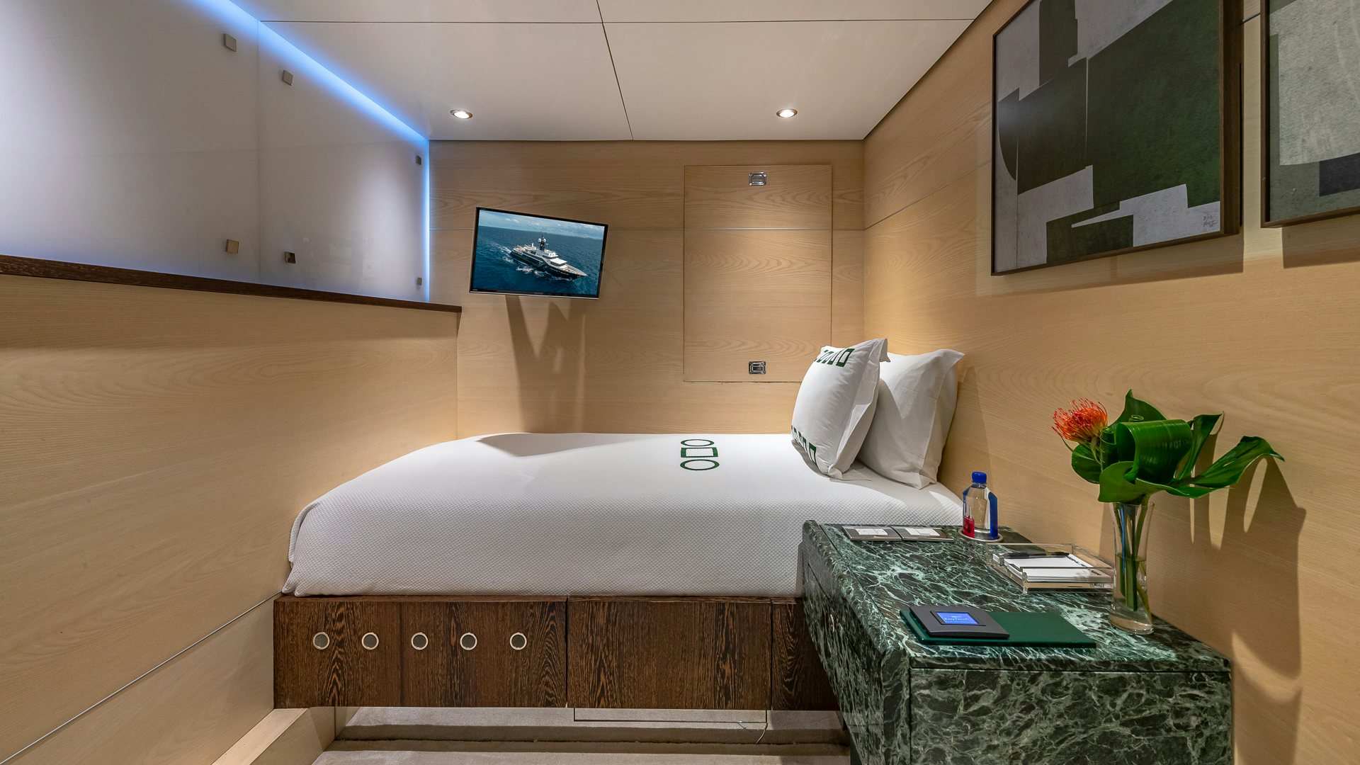 a room with a bed and a table aboard HIGHLANDER Yacht for Charter