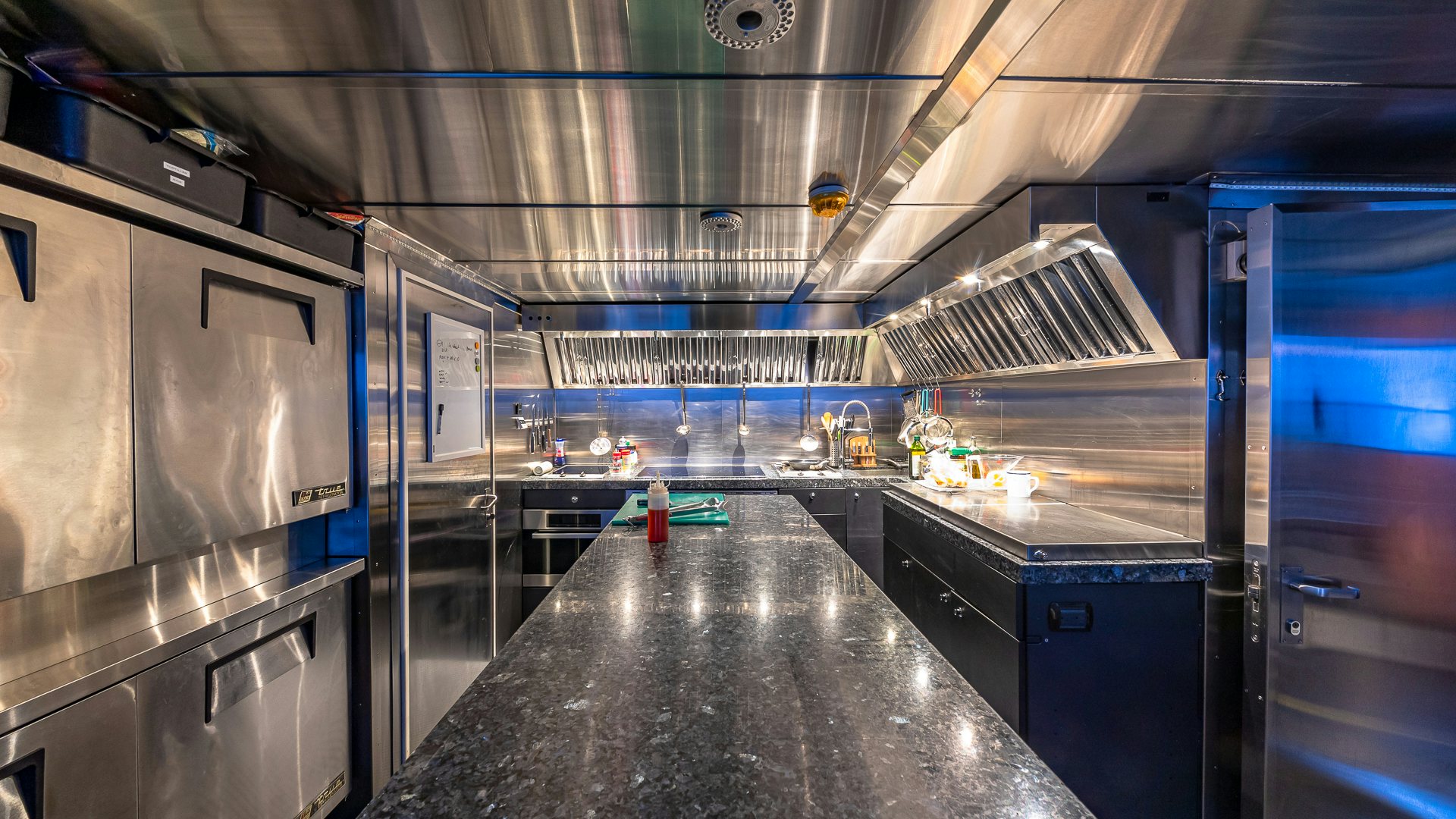 a large kitchen with stainless steel counter tops aboard HIGHLANDER Yacht for Charter