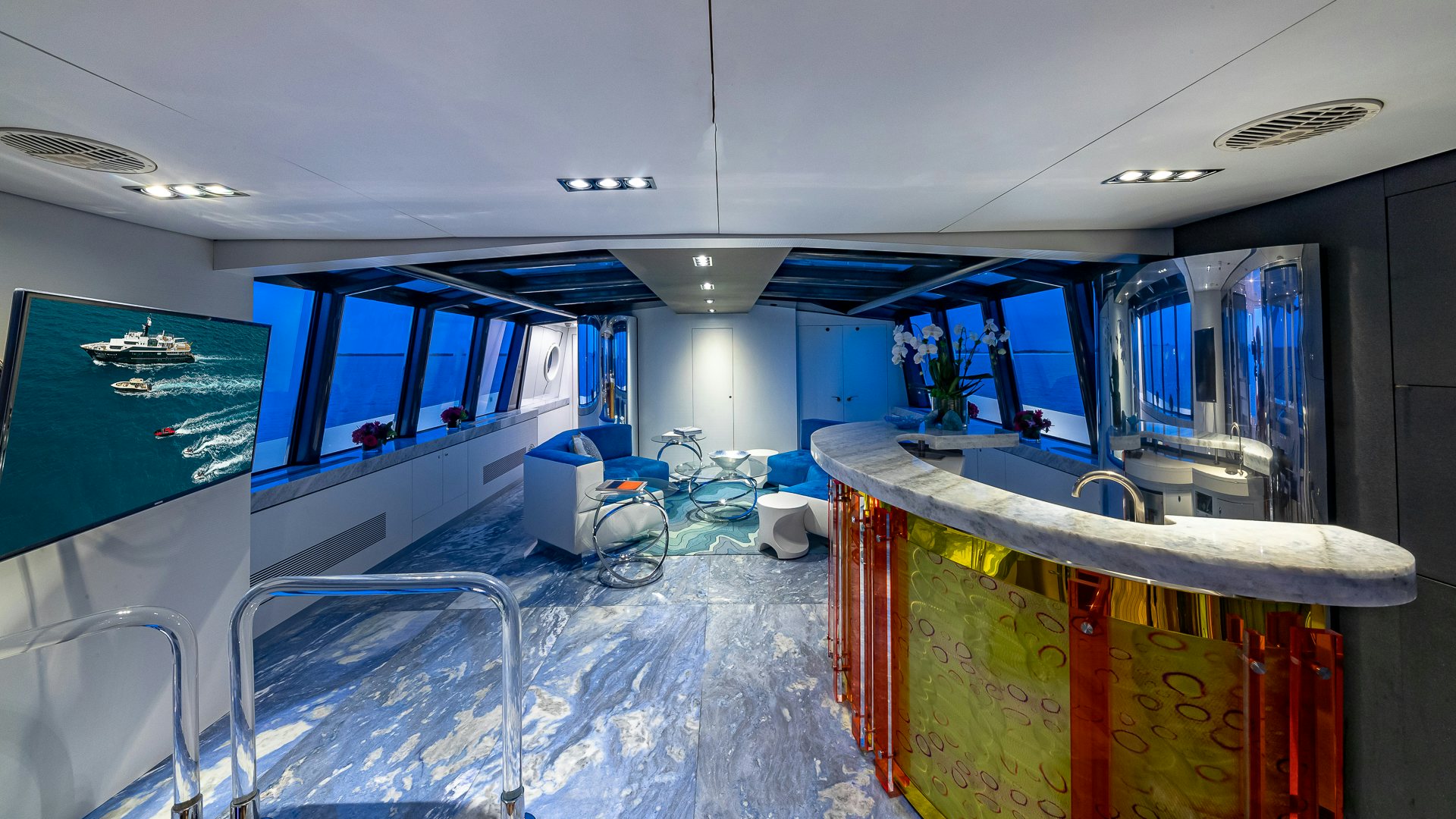 a room with blue walls and a few desks and a few computers aboard HIGHLANDER Yacht for Charter
