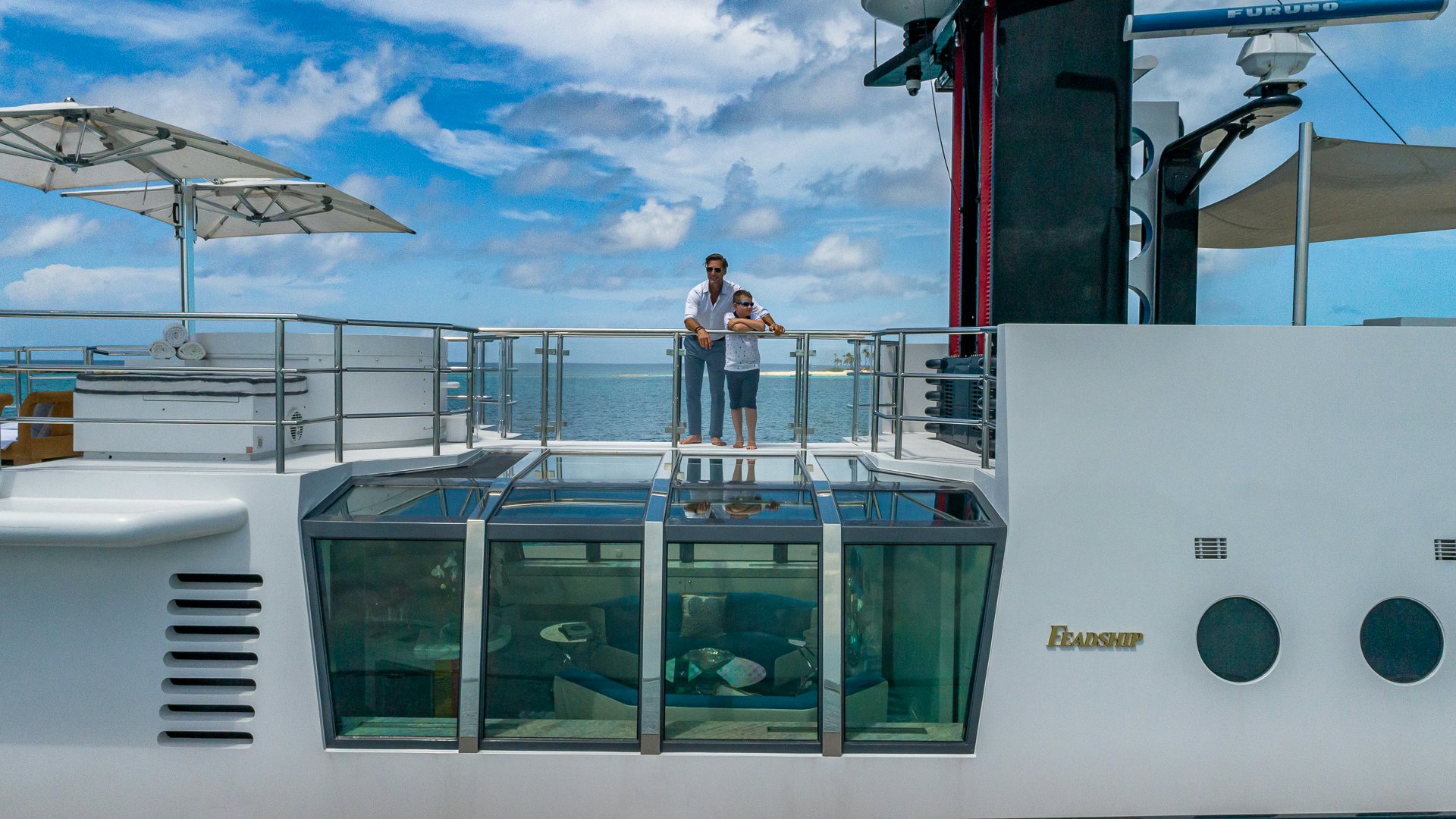 two men standing on a boat aboard HIGHLANDER Yacht for Charter