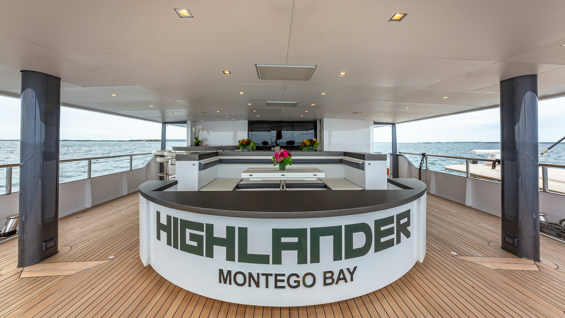 a large room with a large balcony aboard HIGHLANDER Yacht for Charter