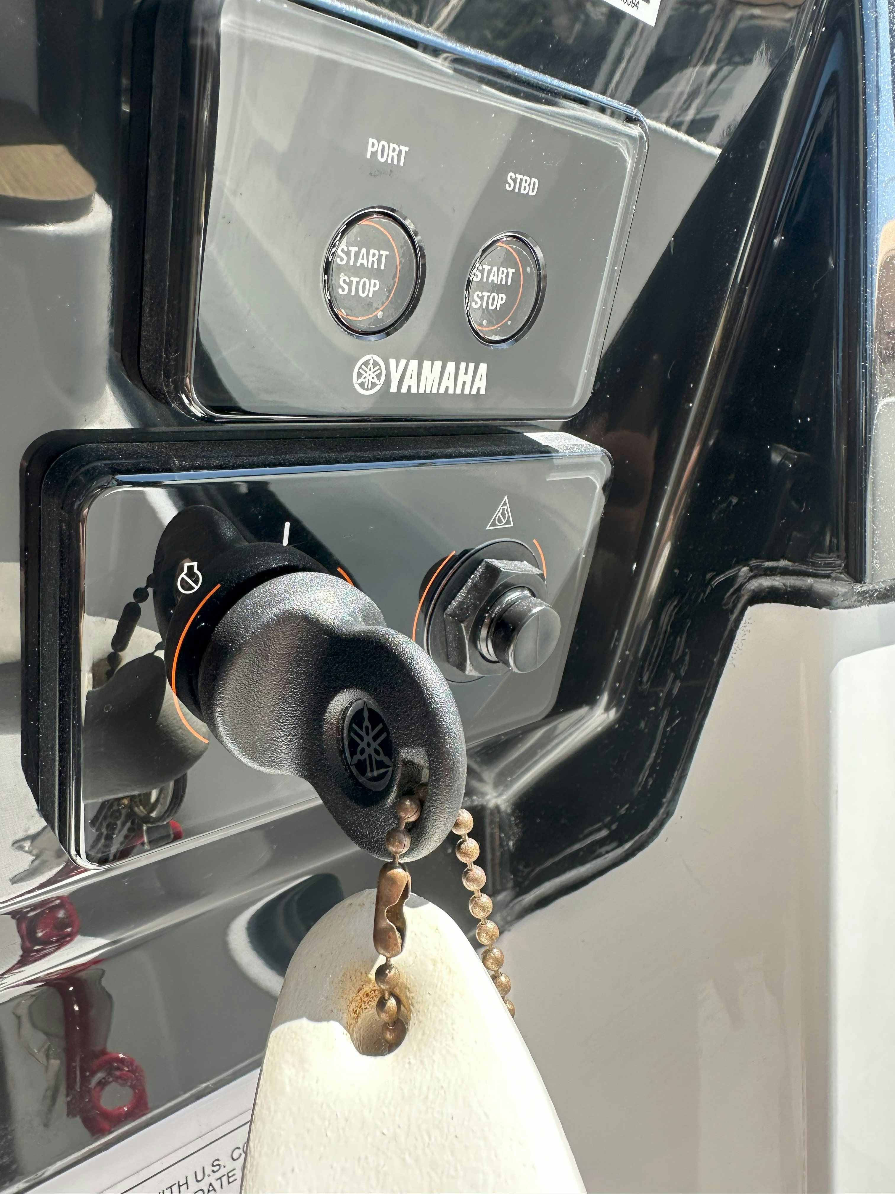 a close-up of a car's steering wheel aboard DESTINATION UNKNOWN II Yacht for Sale