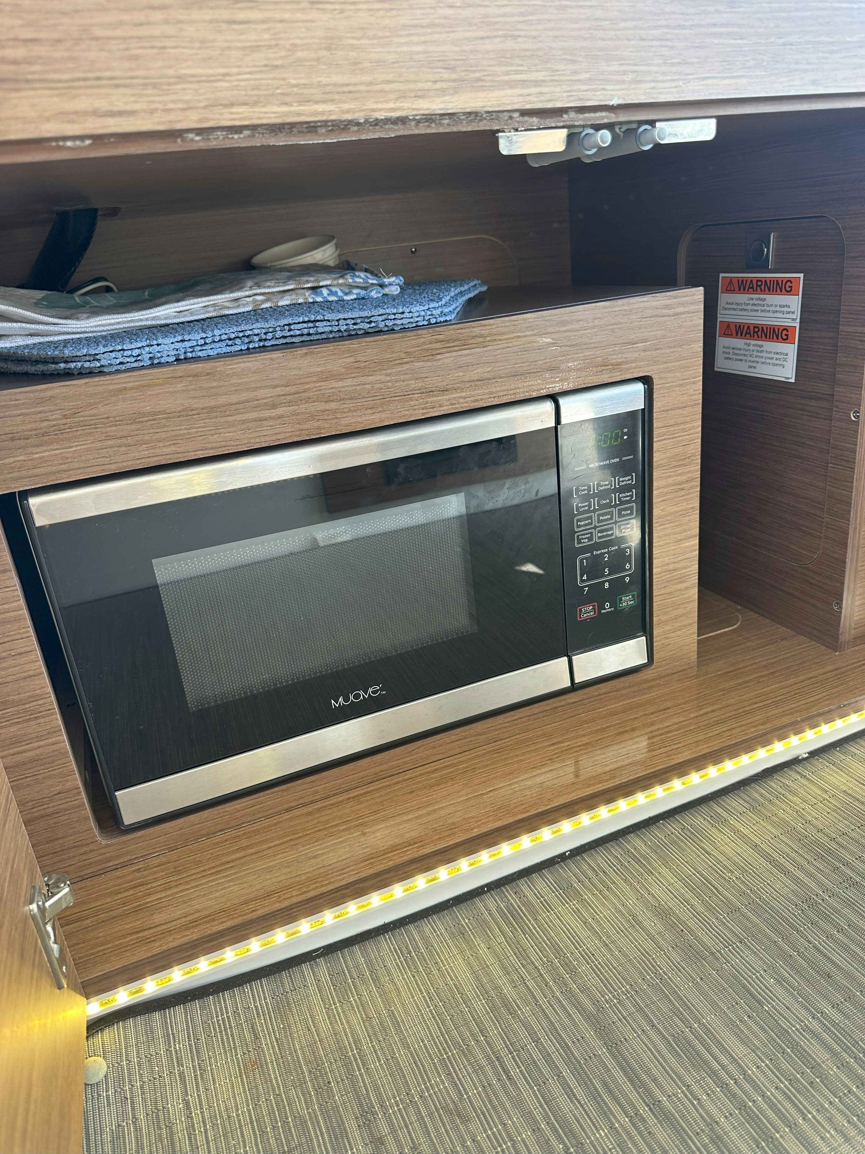 a microwave oven on a counter aboard DESTINATION UNKNOWN II Yacht for Sale