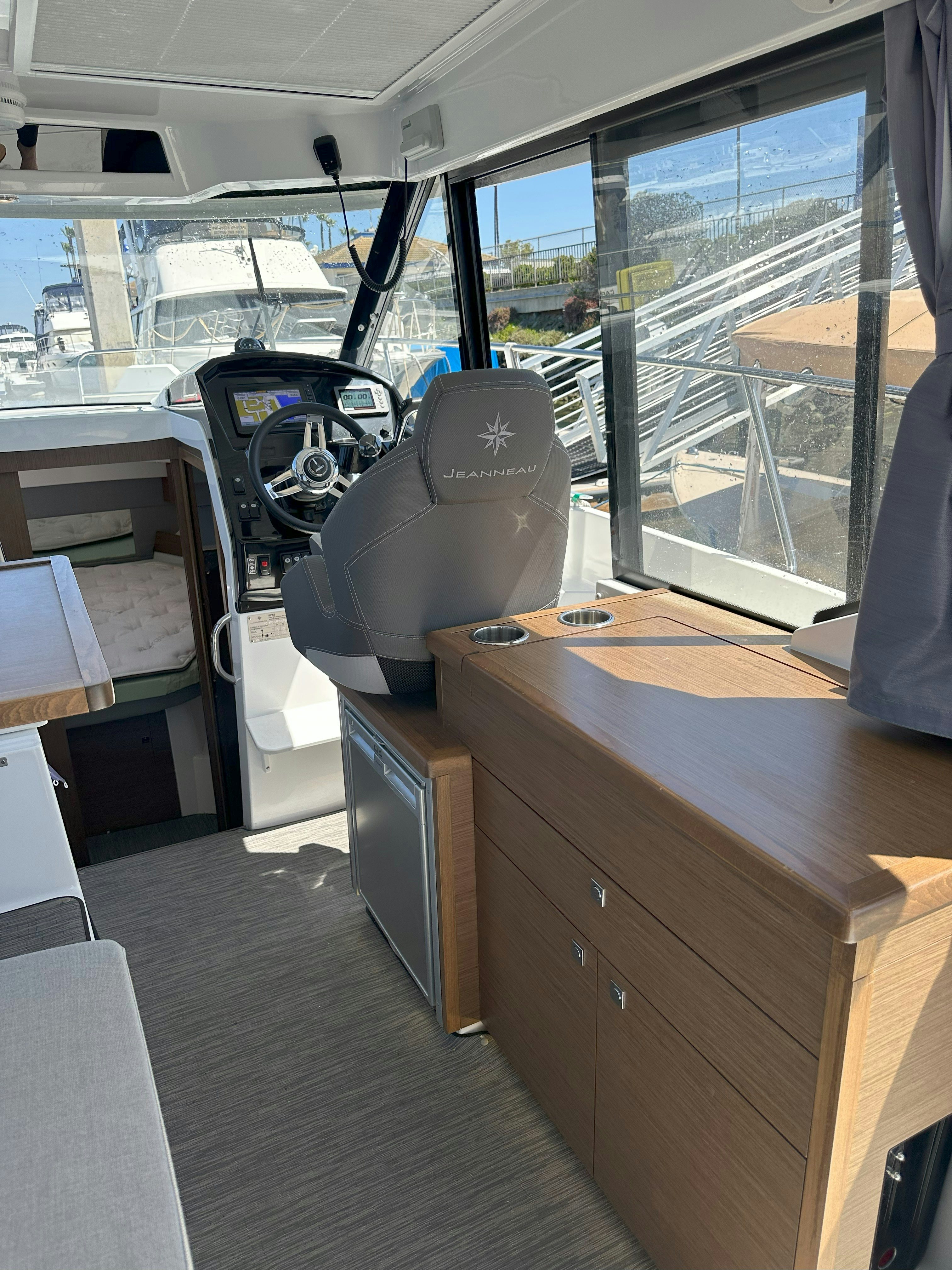 a desk with a computer on it aboard DESTINATION UNKNOWN II Yacht for Sale