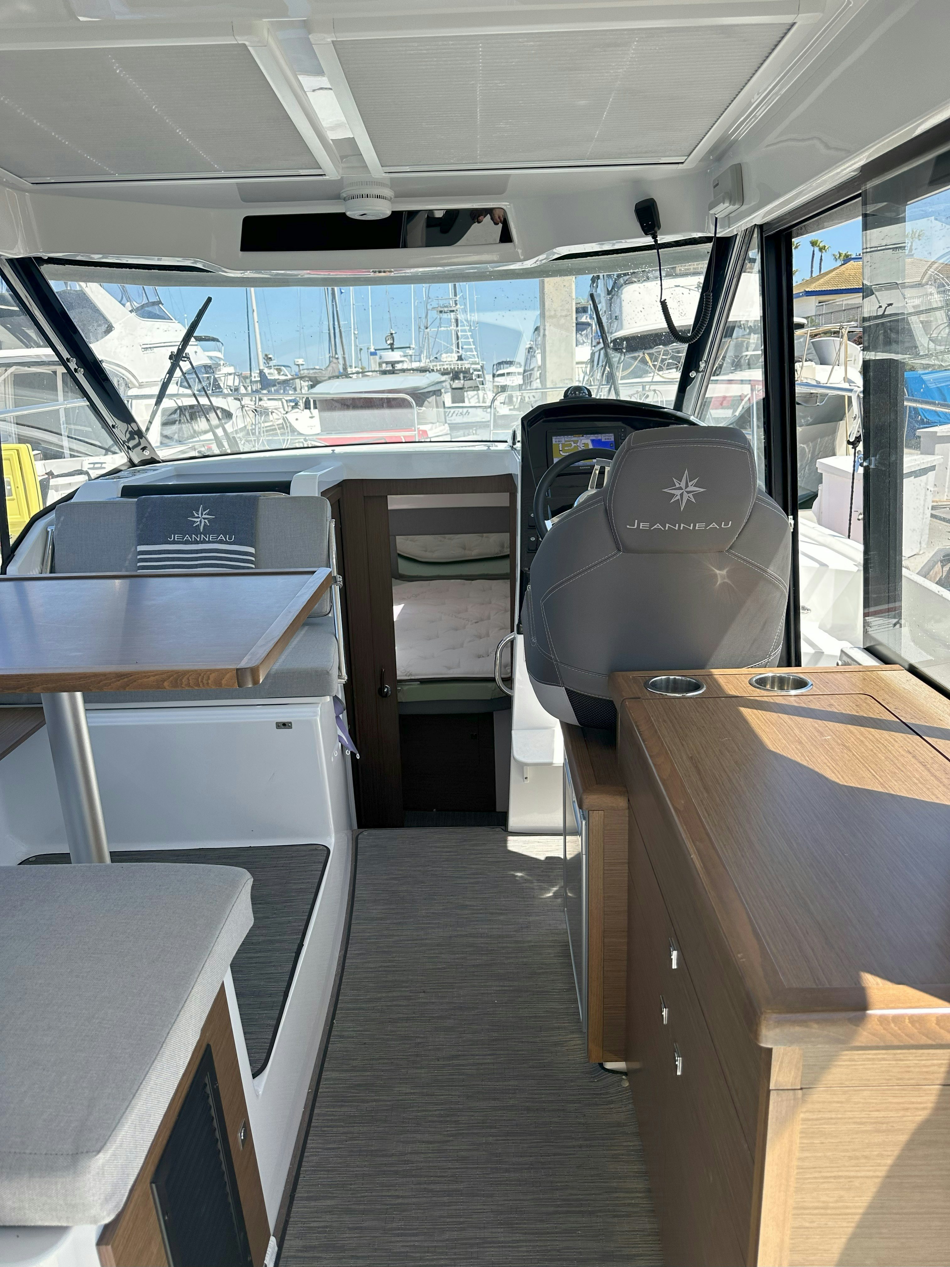 a bus with a desk and chairs aboard DESTINATION UNKNOWN II Yacht for Sale