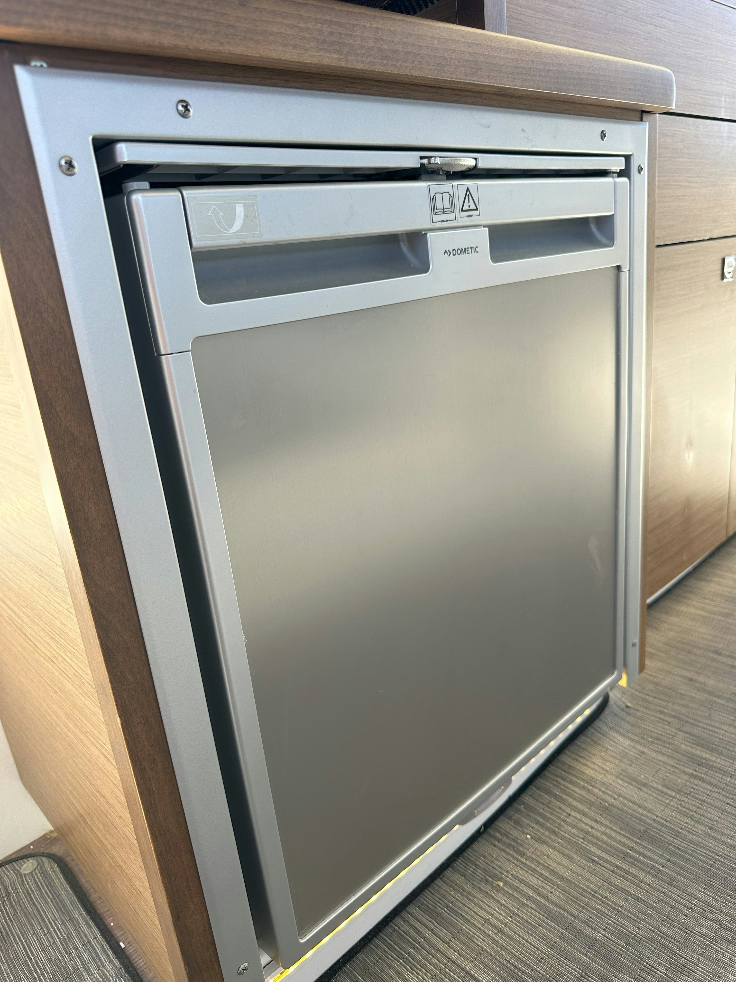 a white refrigerator in a kitchen aboard DESTINATION UNKNOWN II Yacht for Sale