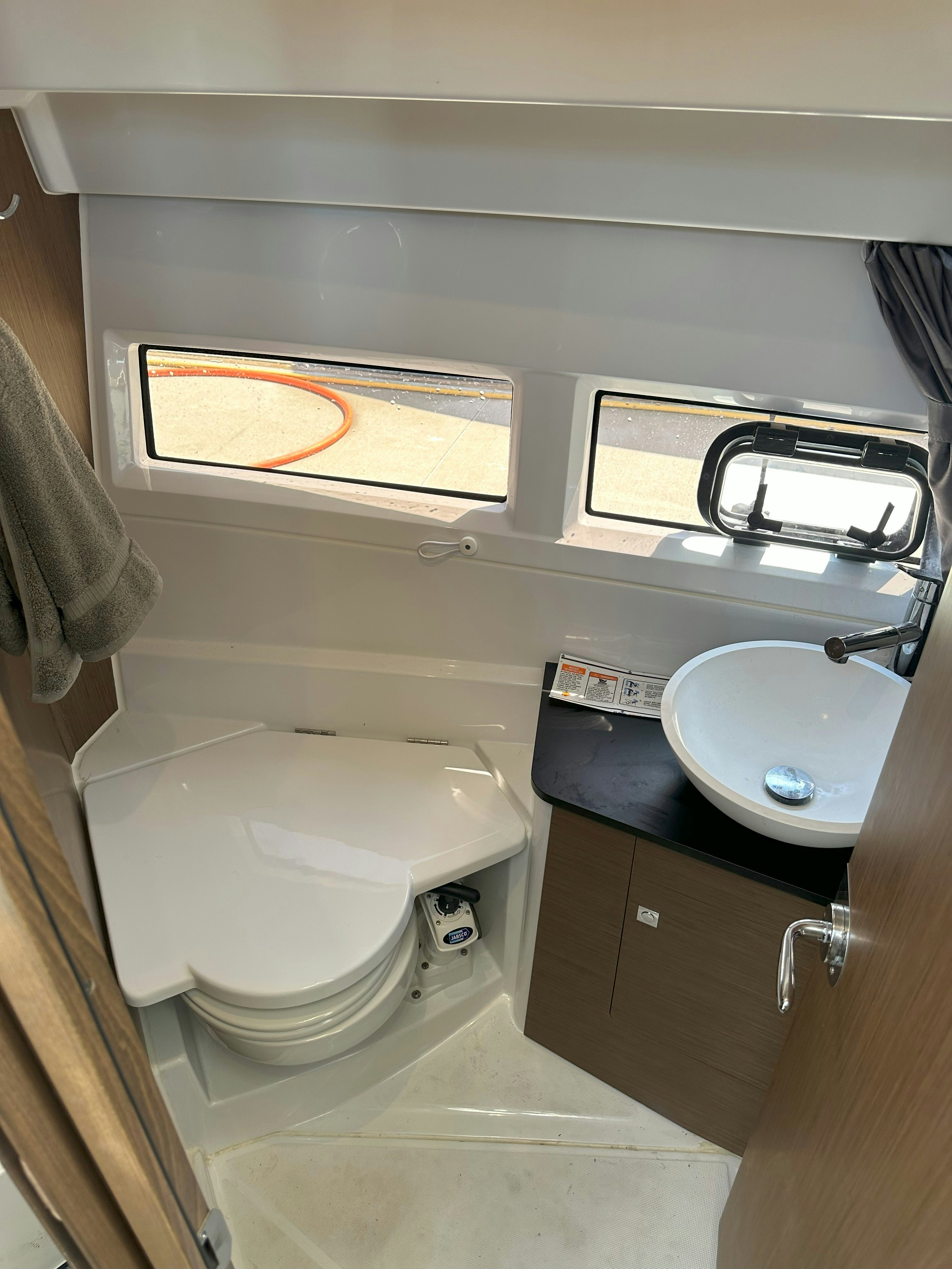 a bathroom with a sink and toilet aboard DESTINATION UNKNOWN II Yacht for Sale