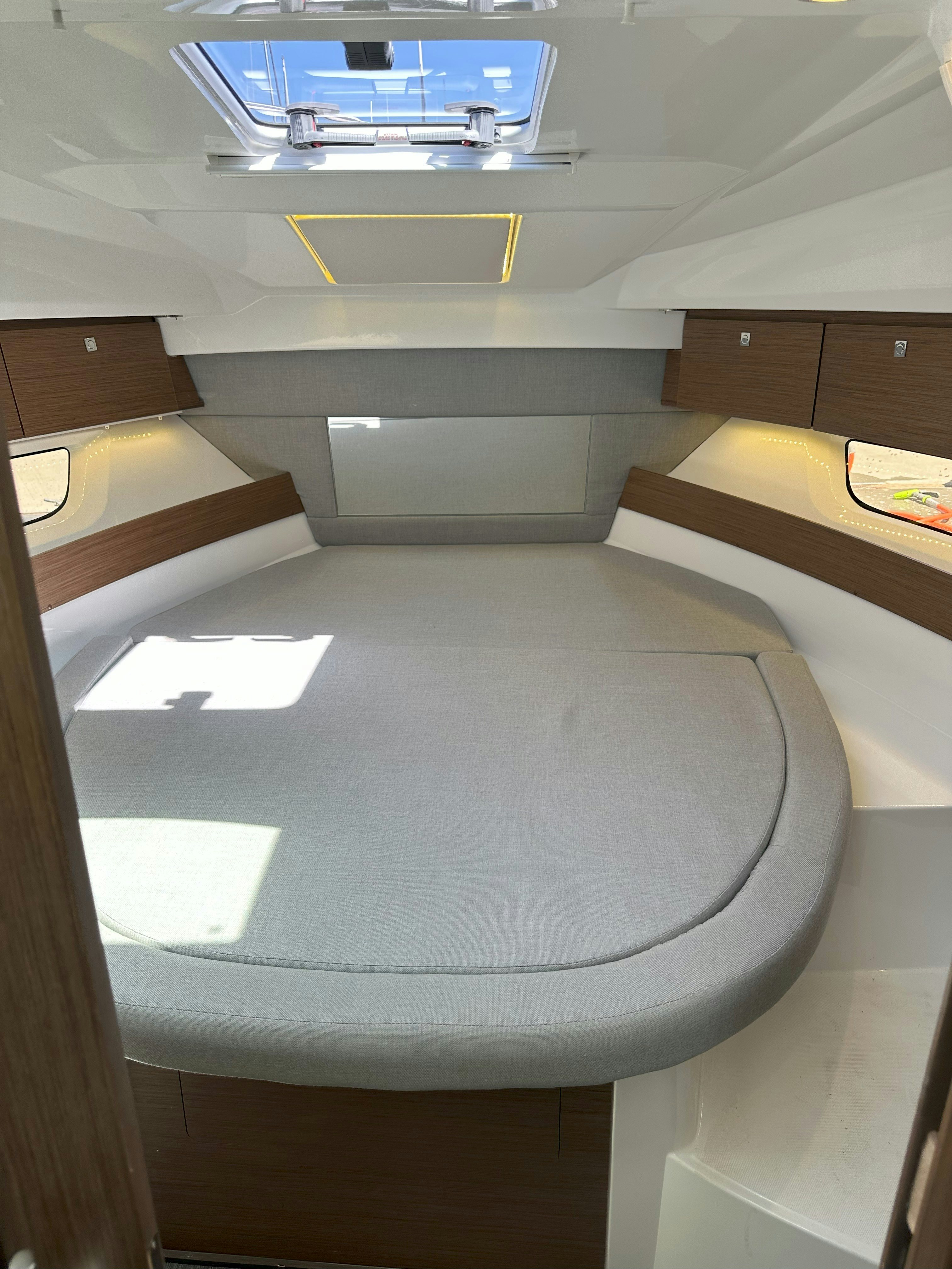 a room with a bed and desk aboard DESTINATION UNKNOWN II Yacht for Sale