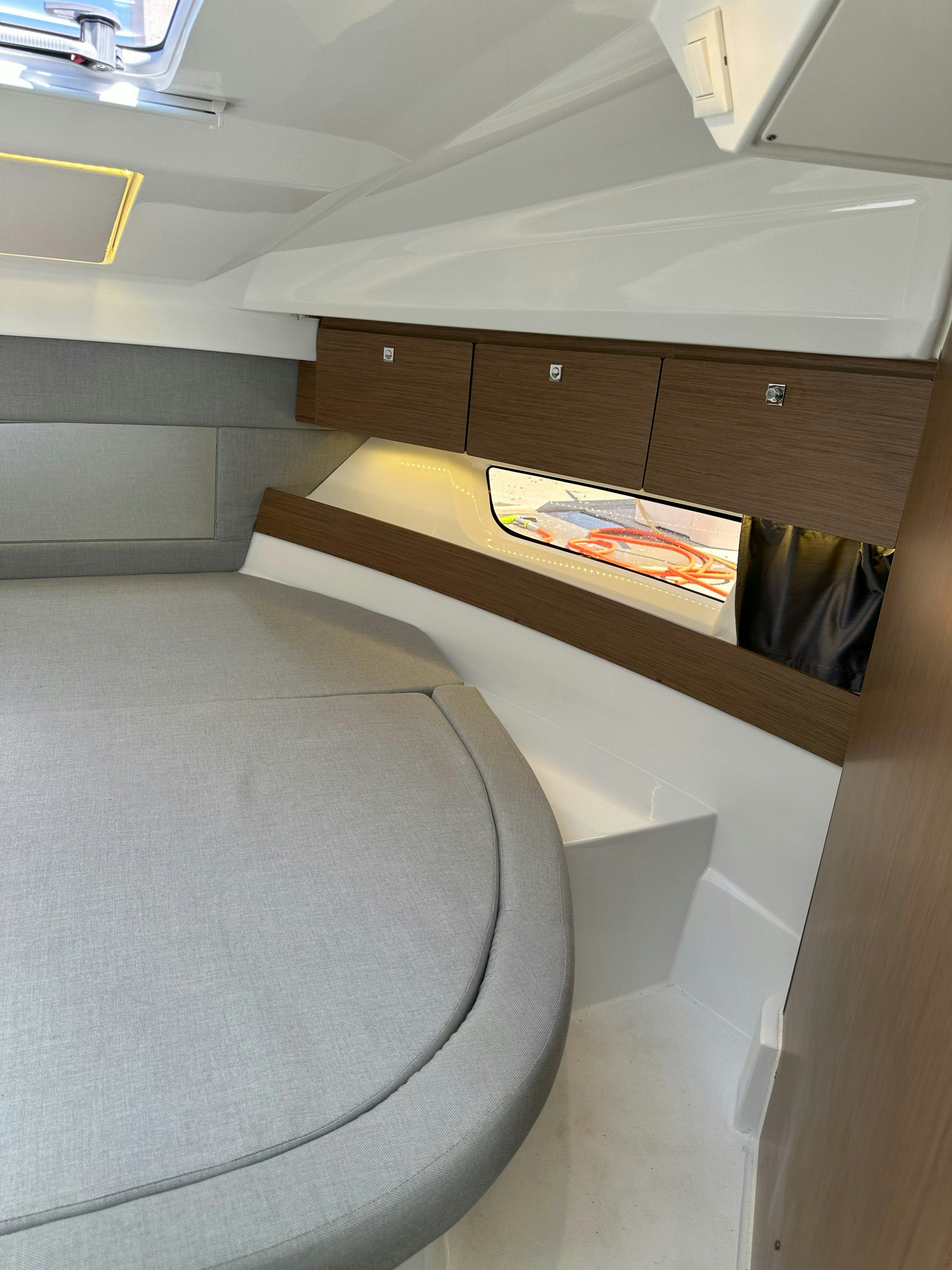 a room with a bed and a table aboard DESTINATION UNKNOWN II Yacht for Sale