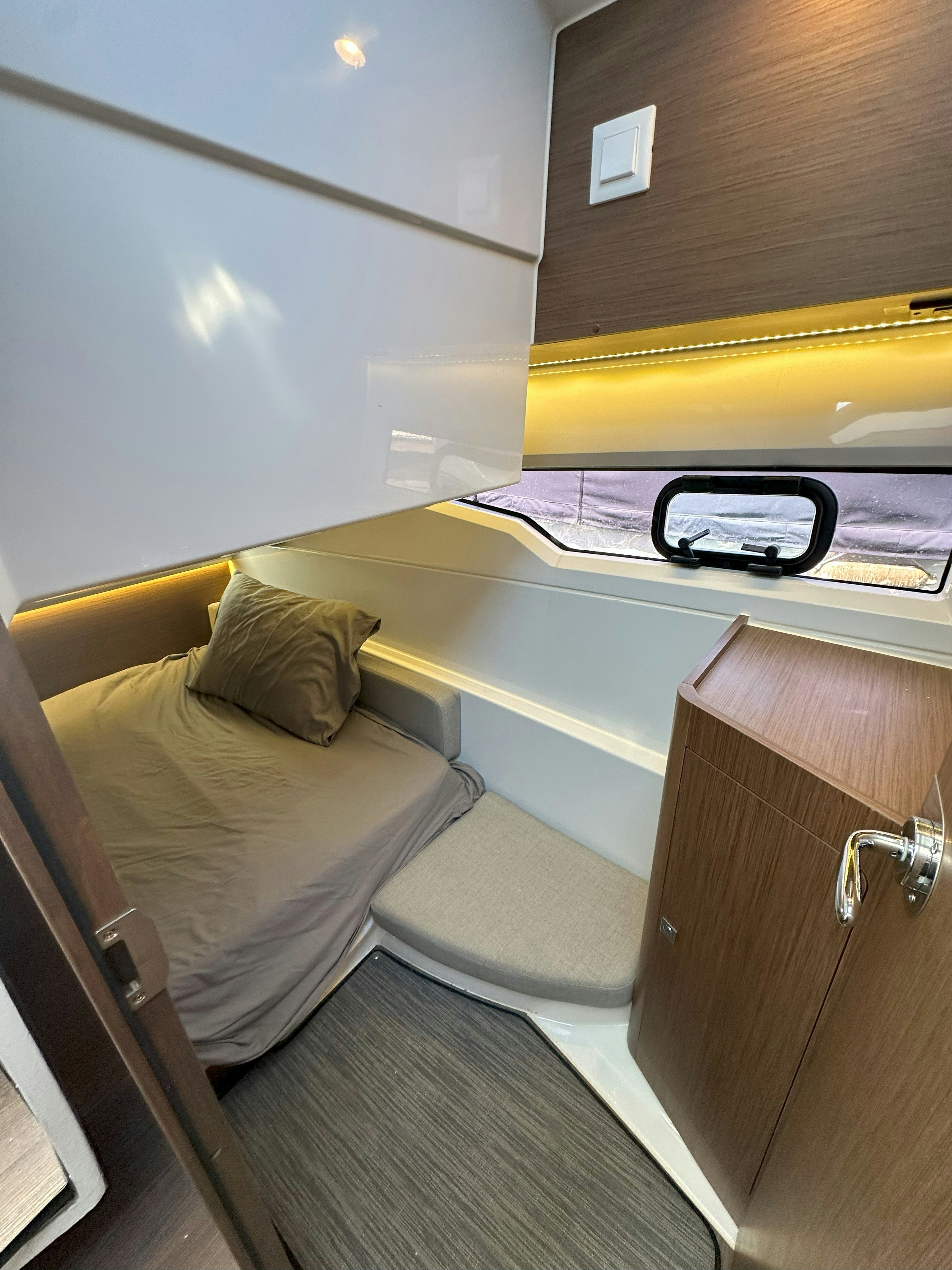 a room with a bed and a desk aboard DESTINATION UNKNOWN II Yacht for Sale